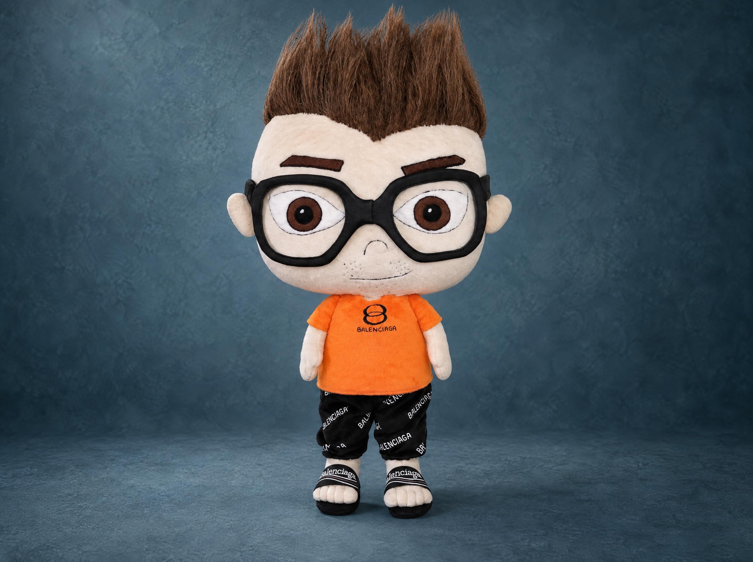 Custom anime doll of a young man with spiky brown hair, big black glasses and an orange T-shirt, made to order