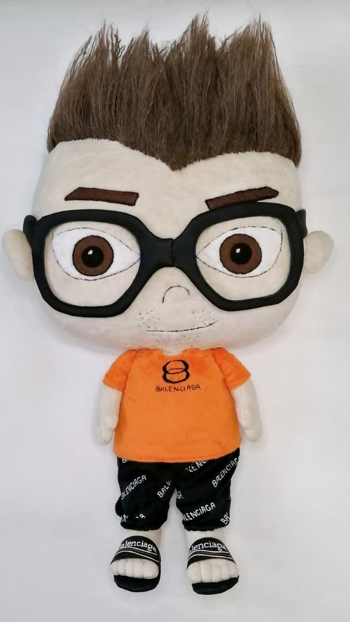 Custom anime doll of a friend in an orange T-shirt, lettering-print shorts and slides, sewn to order