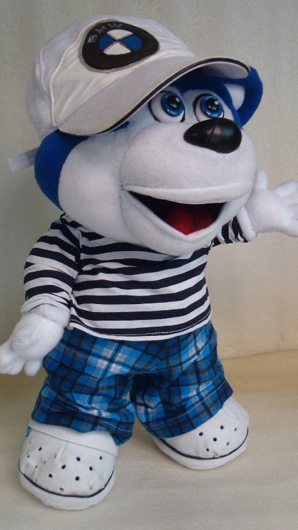 Custom bear plush from a drawing waving a white five-finger hand, wearing a white cap and plaid pants, handmade