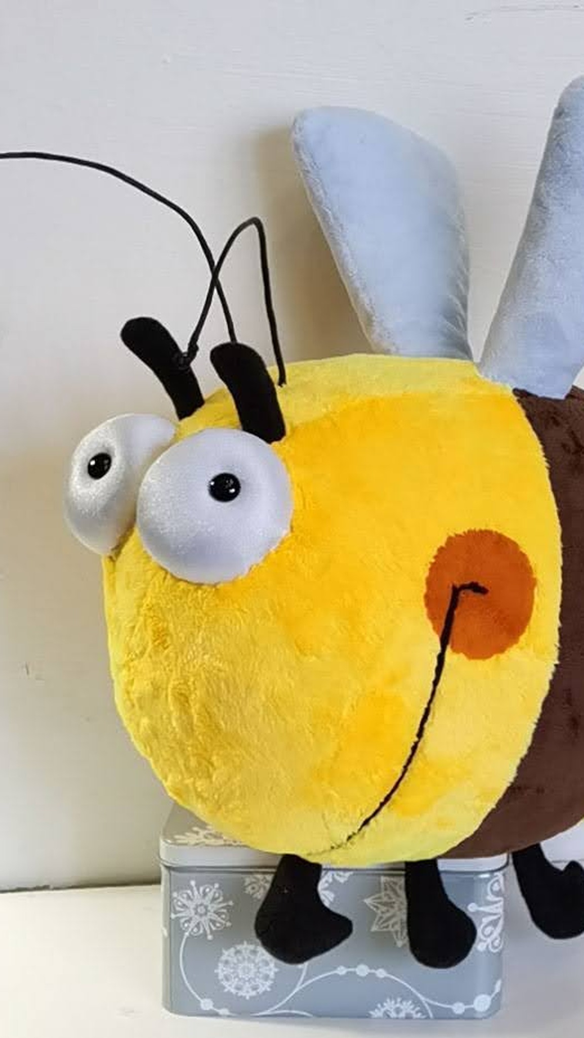 Custom bee plush in soft yellow plush with a brown stripe, googly eyes and grey-blue wings, sewn to order