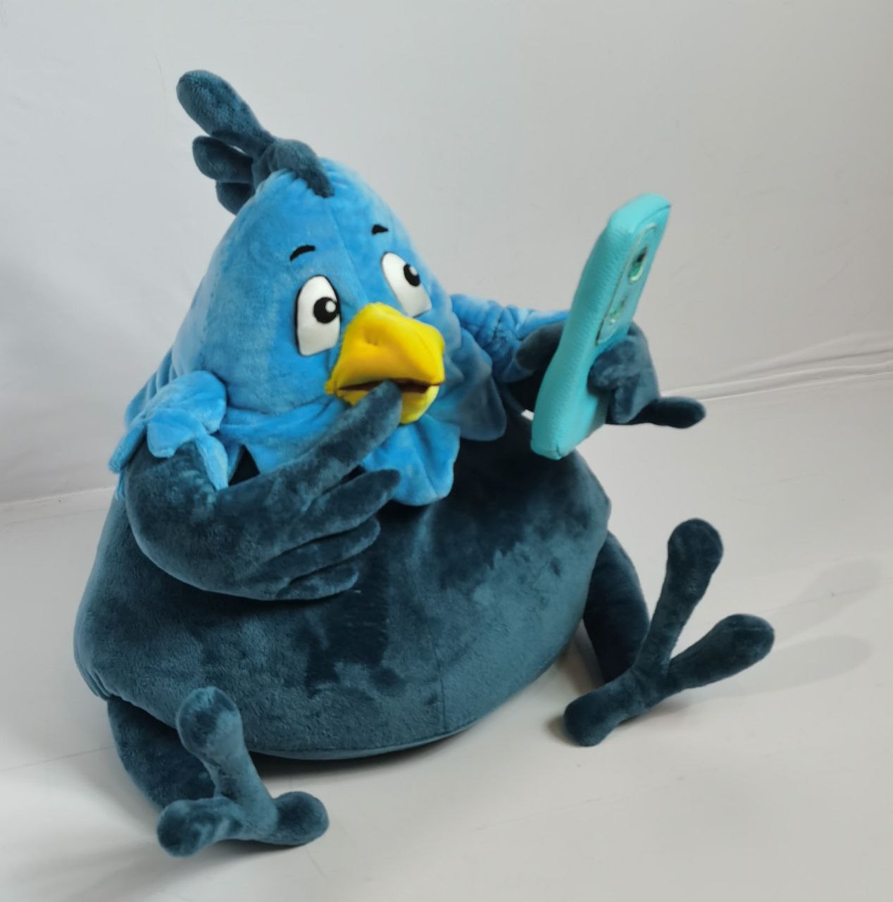 Custom bird plush with a phone Custom bird plush with a wing to its beak and a phone in the other, dark teal mottled plush, made to order