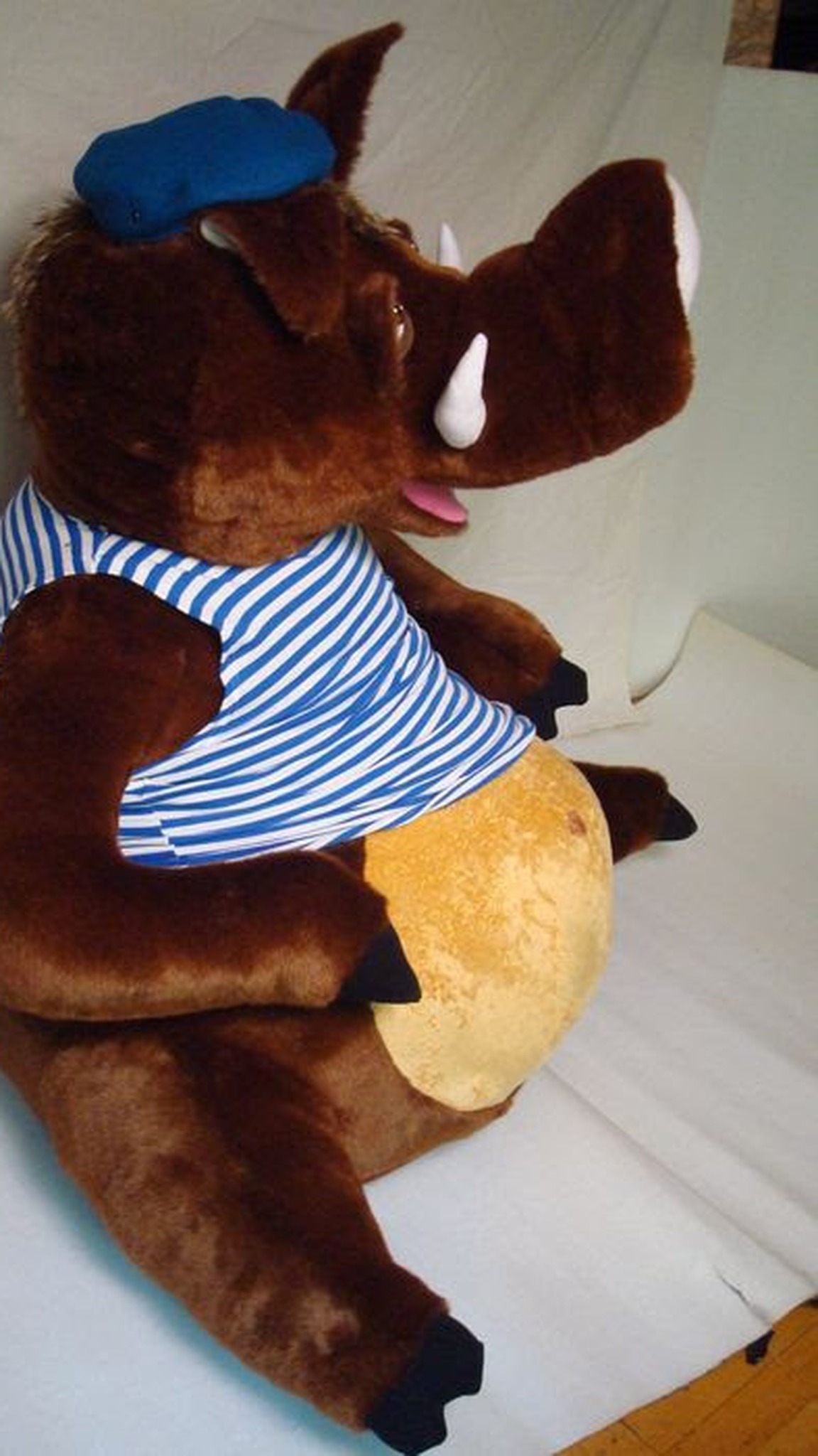 Custom boar plush, handmade to order: white tusks, pink tongue, striped vest over a round golden belly