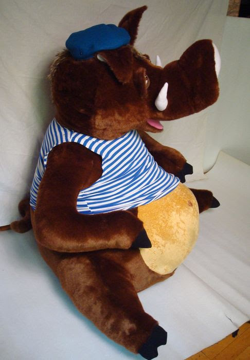 Custom boar plush with tusks and a striped vest Custom boar plush, handmade to order: white tusks, pink tongue, striped vest over a round golden belly