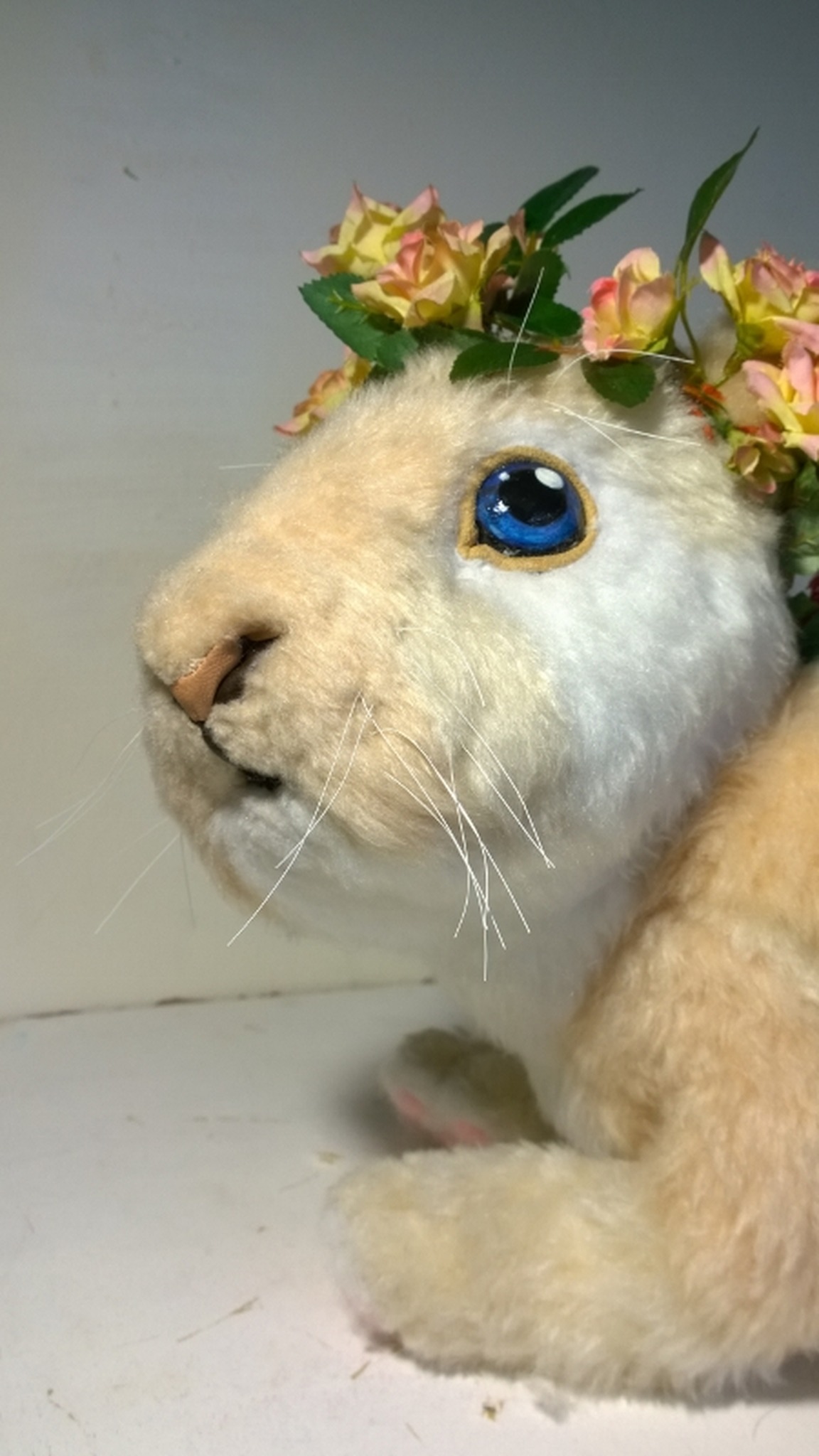 Custom bunny plush in cream faux fur with a crown of roses and leaves, a handmade realistic rabbit toy