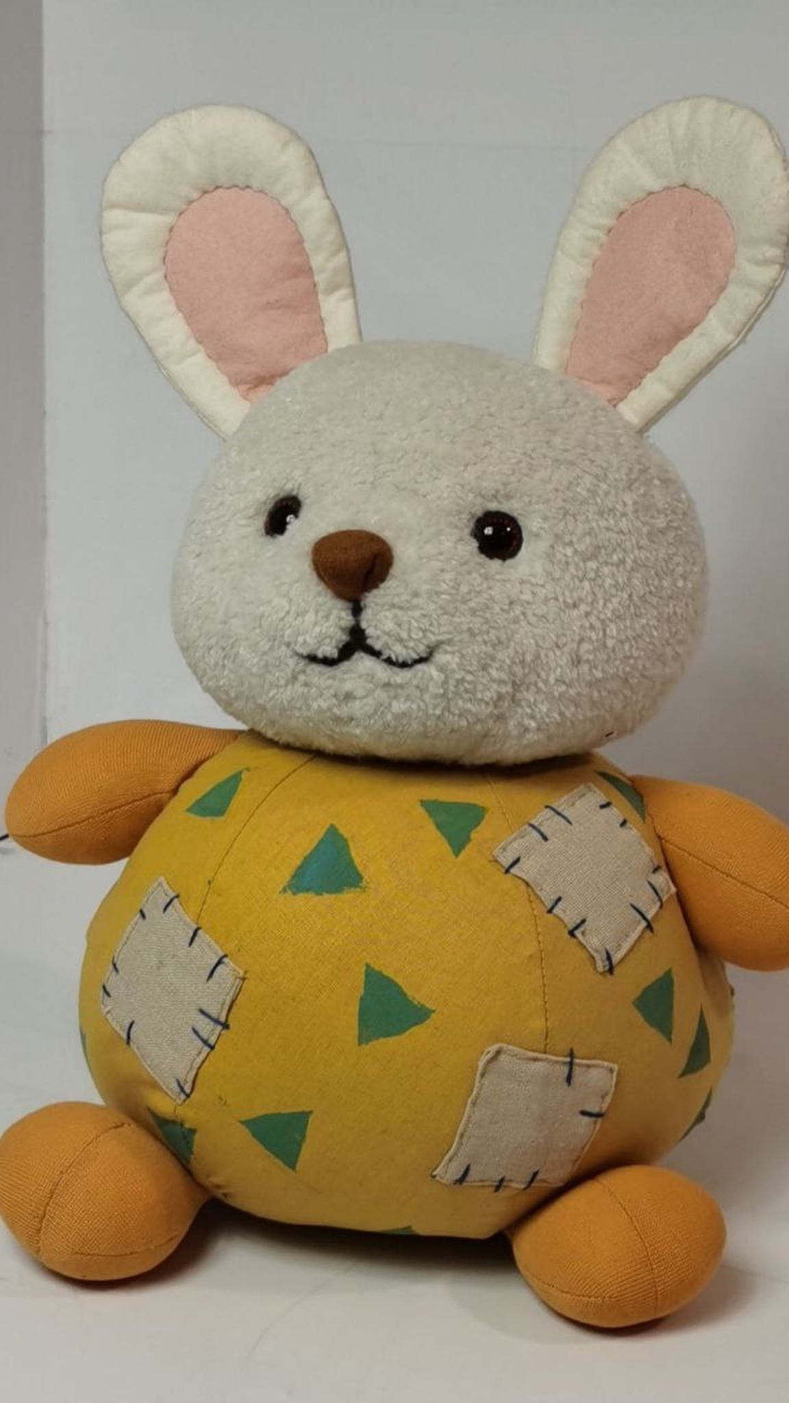 Custom bunny plush with black eyes, a brown nose and a stitched smile, sewn to order from a picture found online