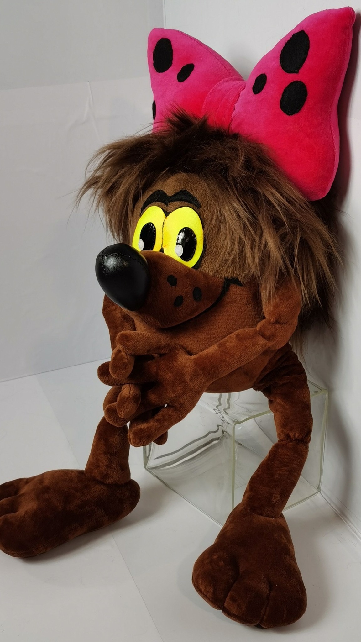 Custom cartoon plush of Dyudyuka with her long fingers laced together, handmade in brown plush and faux fur