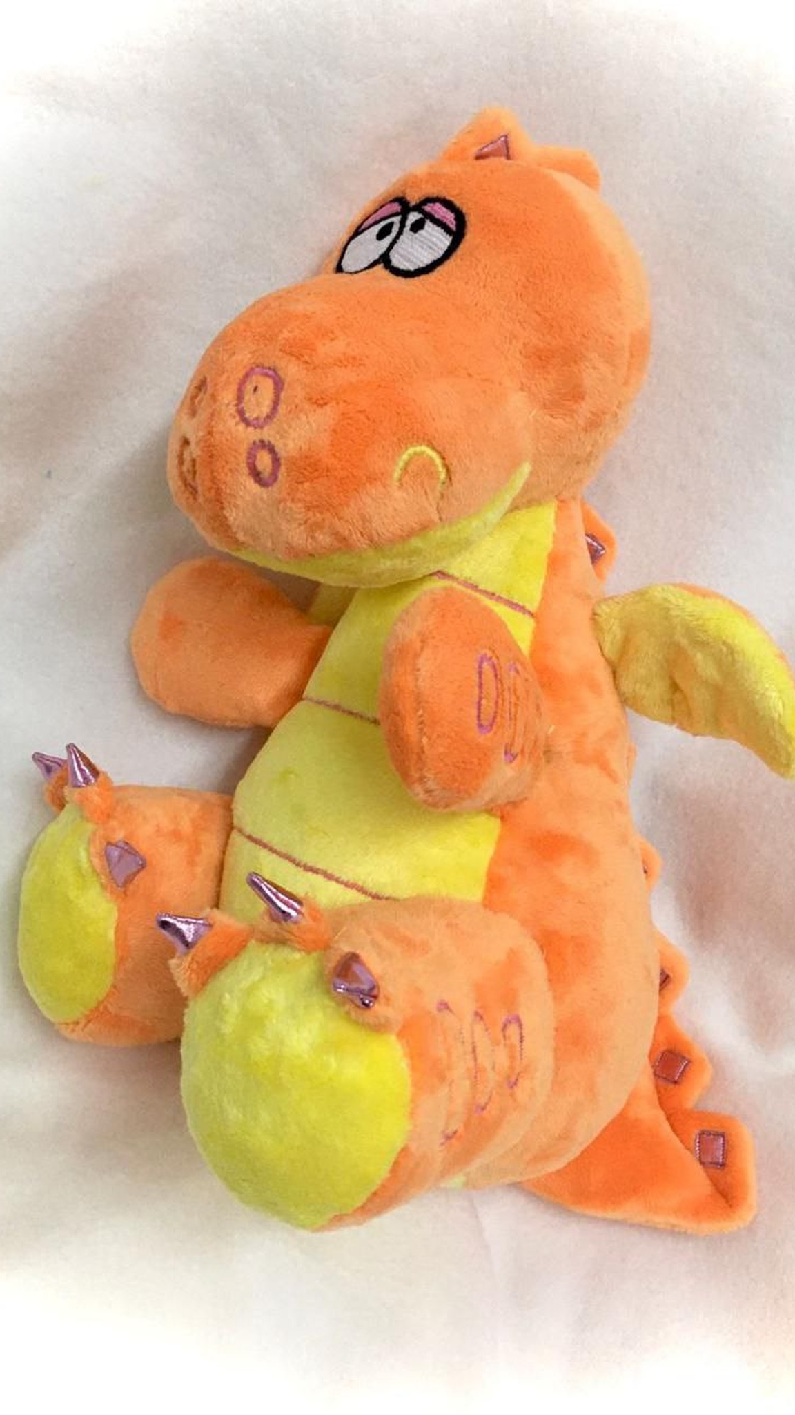Custom dragon stuffed animal in orange plush with a striped lime belly, purple claws and spikes, made to order