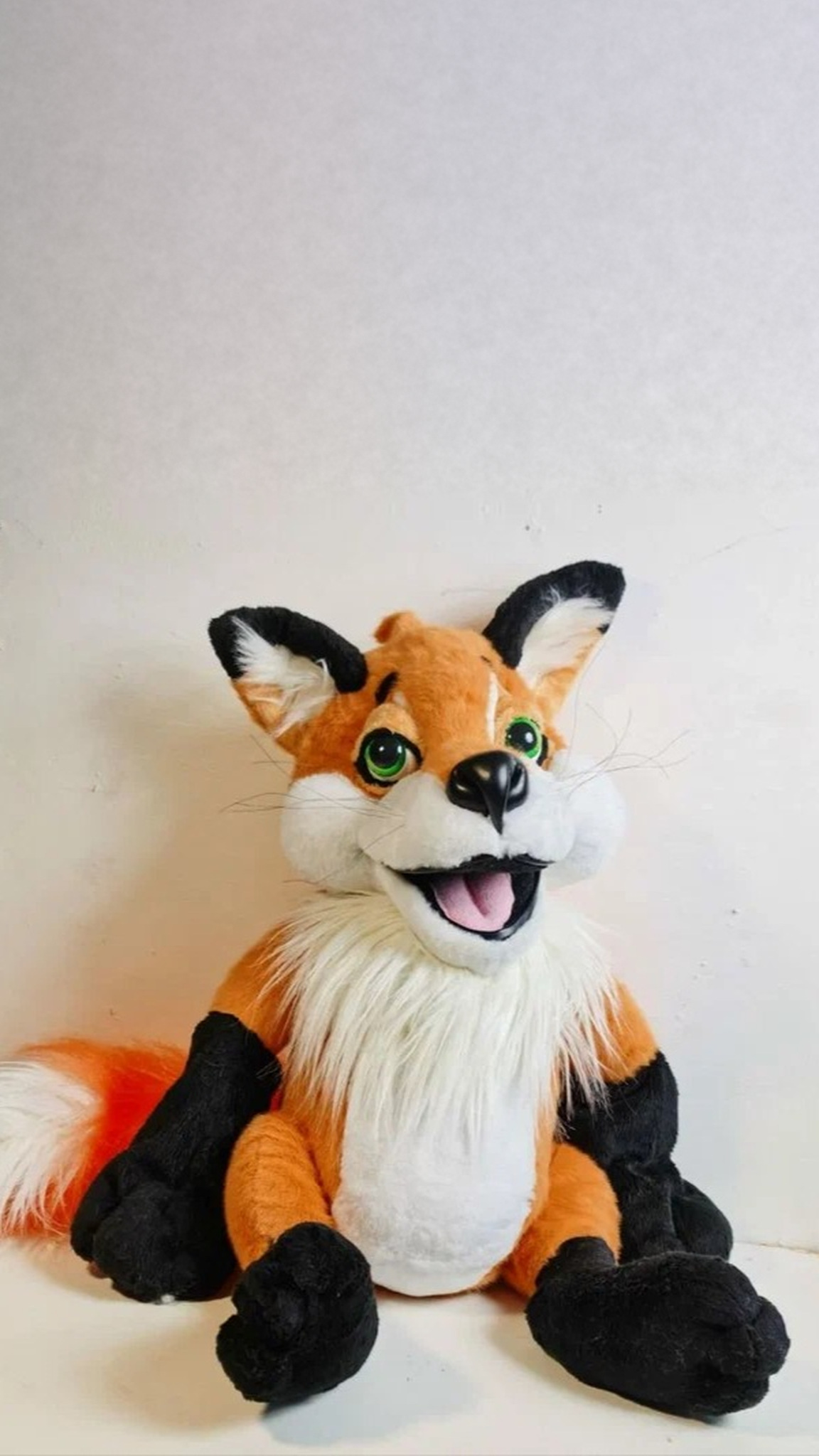 Handmade fox plush sitting with a white faux fur ruff, black paws and a ginger tail, made to order