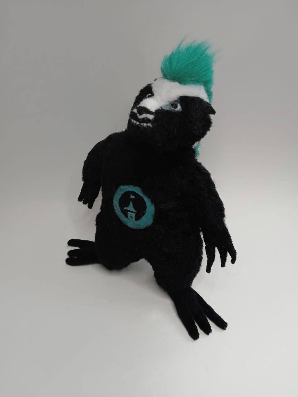 Custom honey badger plush with a grin Custom honey badger plush grinning with small white teeth, long clawed paws, teal mohawk, sewn to order