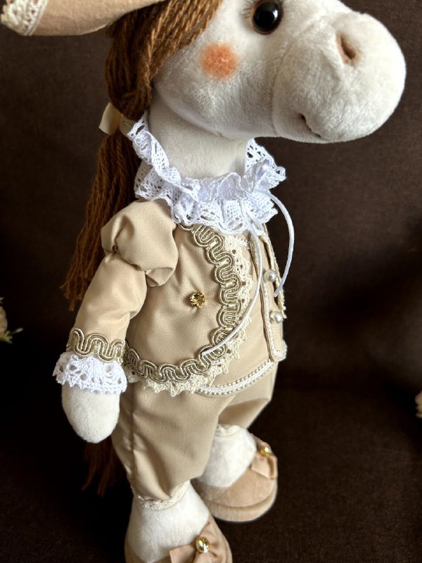 Custom horse plush in a beige suit Custom horse plush in a beige suit with braid trim, buttons and a lace collar, corporate gift made to order