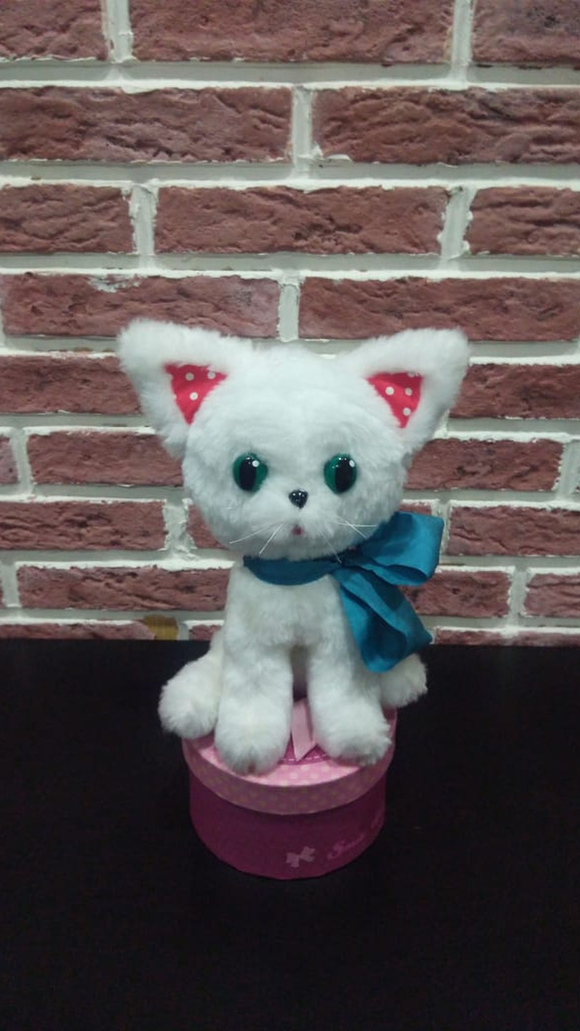 Custom kitten plush in white faux fur sitting up with a teal bow, sewn to order from a picture