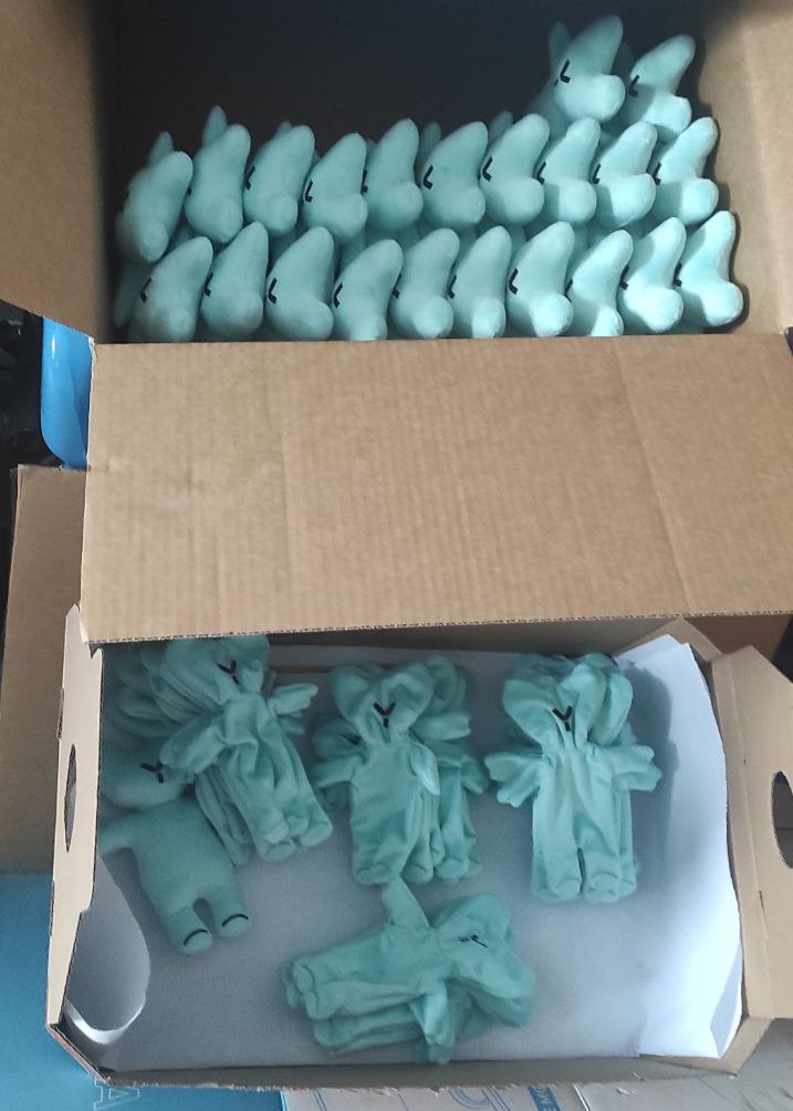 Custom logo teddy bears in production Custom logo teddy bears mid-batch: rows of stuffed mint bears and sewn bodies to fill, made to order