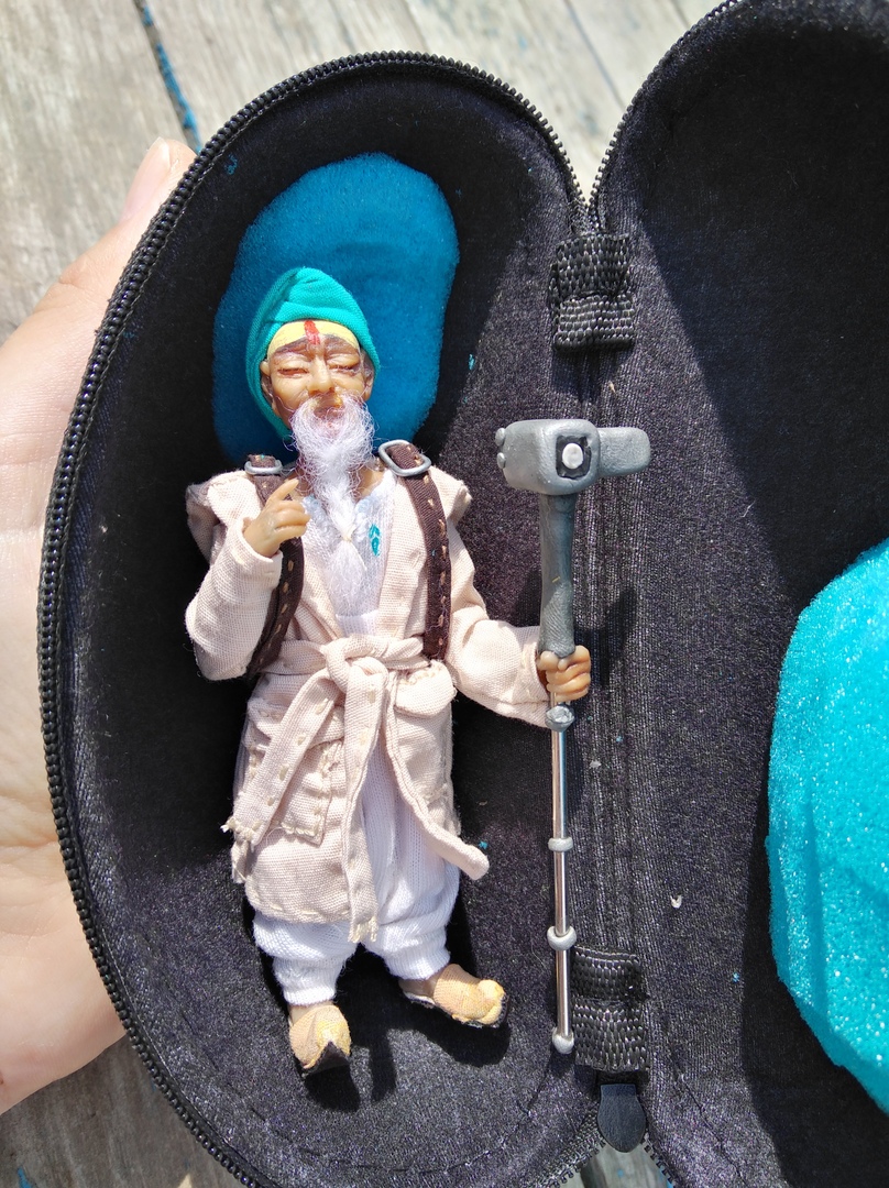 Mascot doll in its travel case Custom mascot doll packed in its black zip travel case with a teal head cushion, sewn to order for the brand