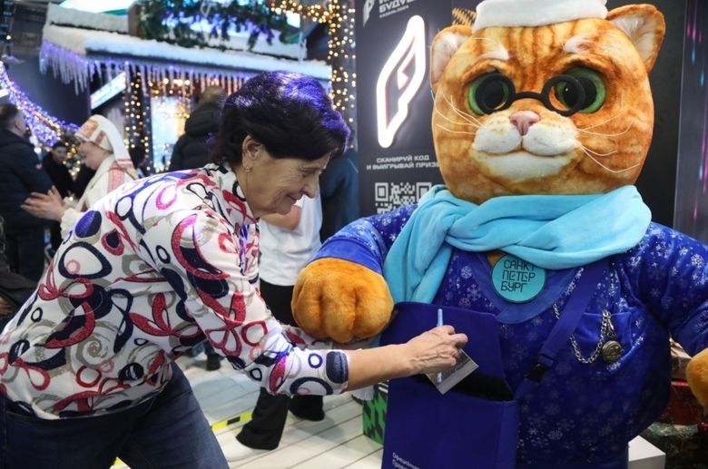 Custom mascot plush cat at an event Custom mascot plush cat at a busy exhibition, a visitor posts a holiday card in his bag, handmade to order