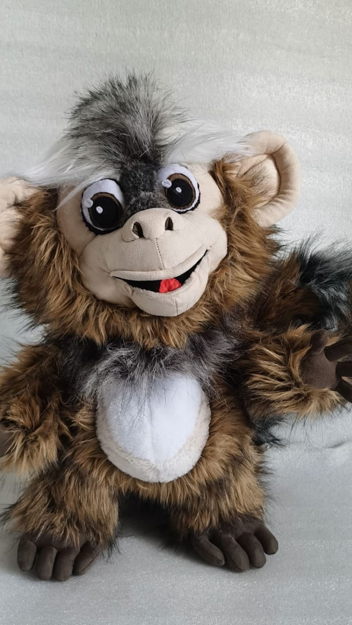 Custom monkey plush of a marmoset with a white and grey faux fur crest and red tongue, handmade