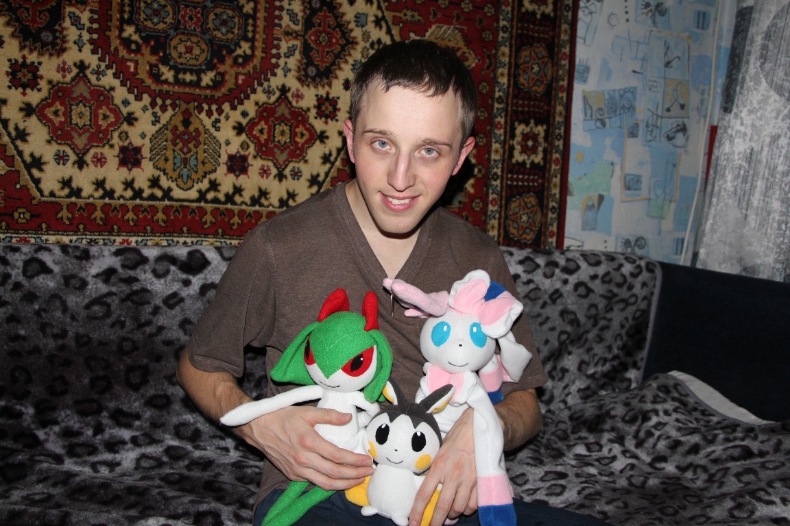Customer with his custom Pokémon plush Our customer hugging his custom Sylveon, Emolga and Kirlia plush, a Pokémon set made to order for him