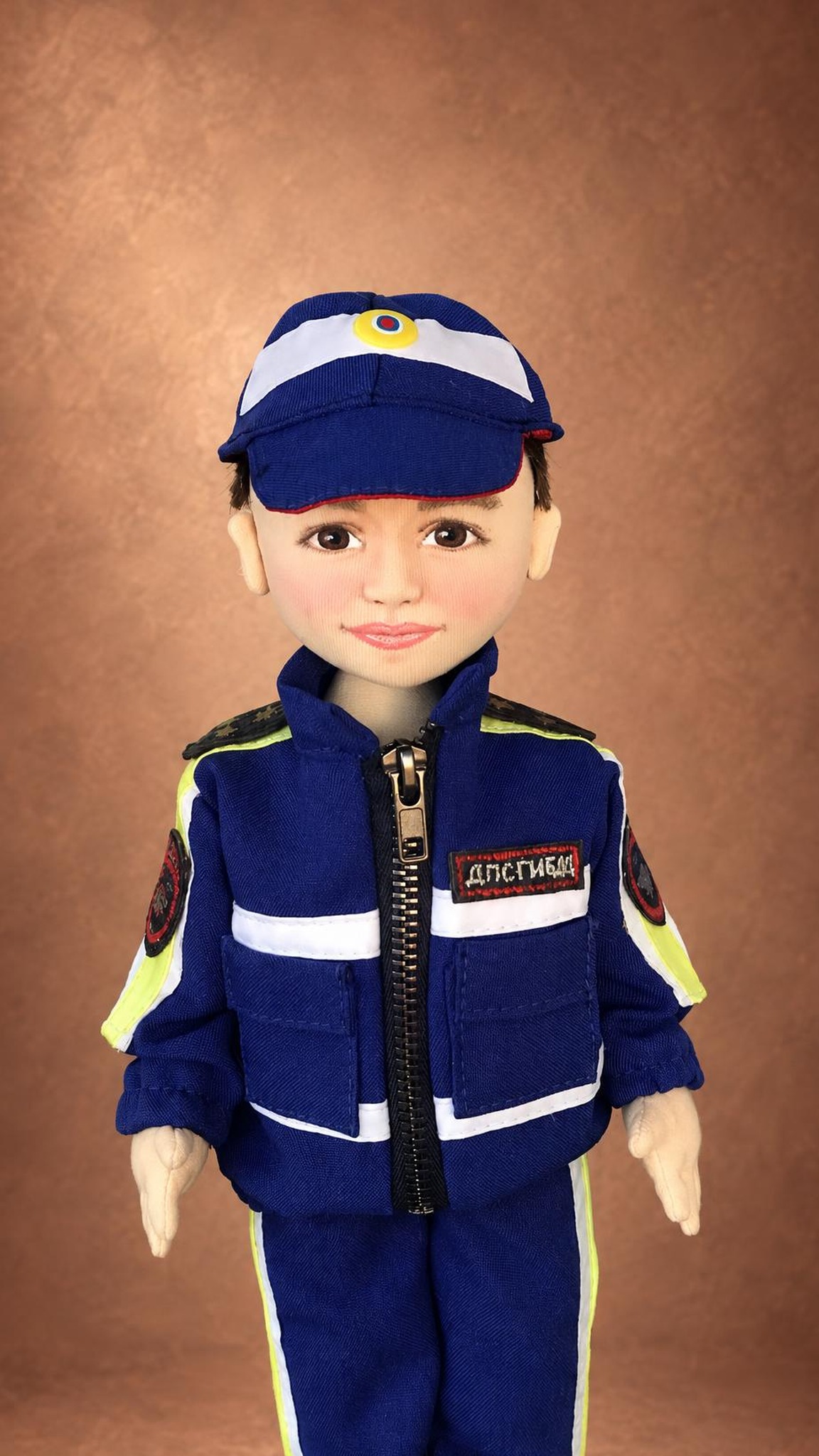 Custom police doll sewn from his photos: blue cap with cockade, zip jacket, DPS GIBDD chest strip, neon trim