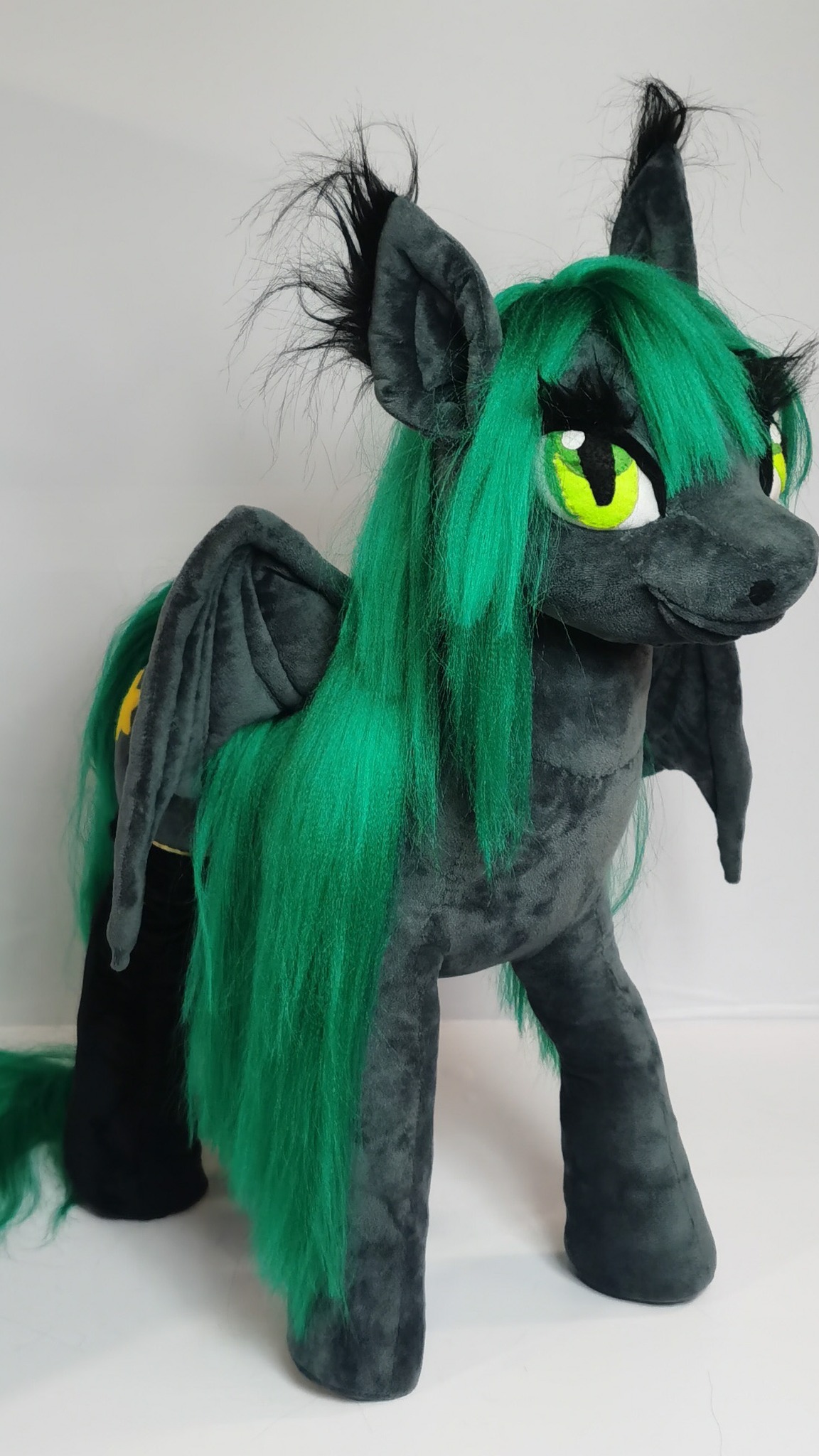 Custom pony plush in graphite grey with a long green mane and big slit green eyes, handmade to order