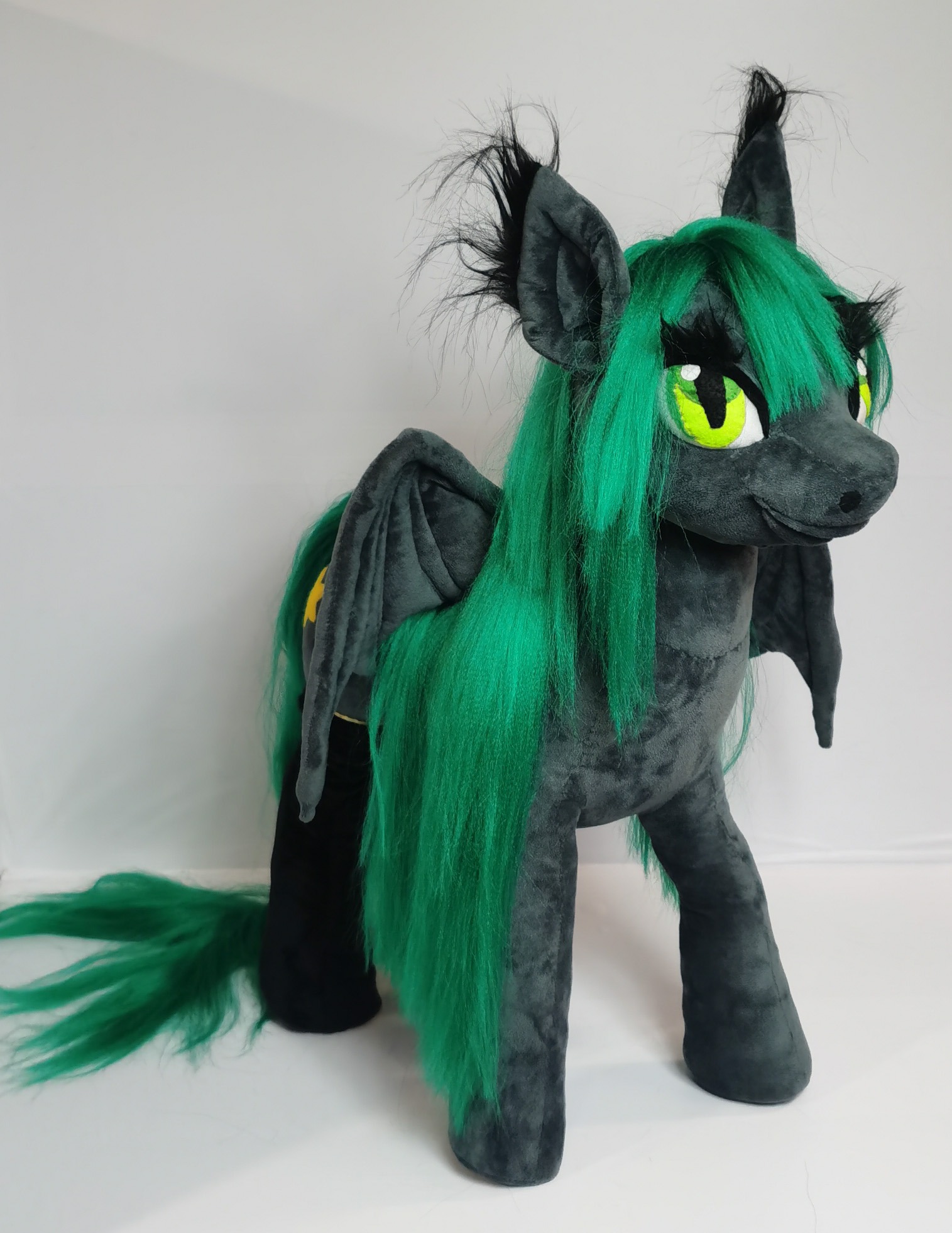 Custom pony plush with a green mane Custom pony plush with a floor-length green mane, slit green eyes and bat wings, handmade for one customer