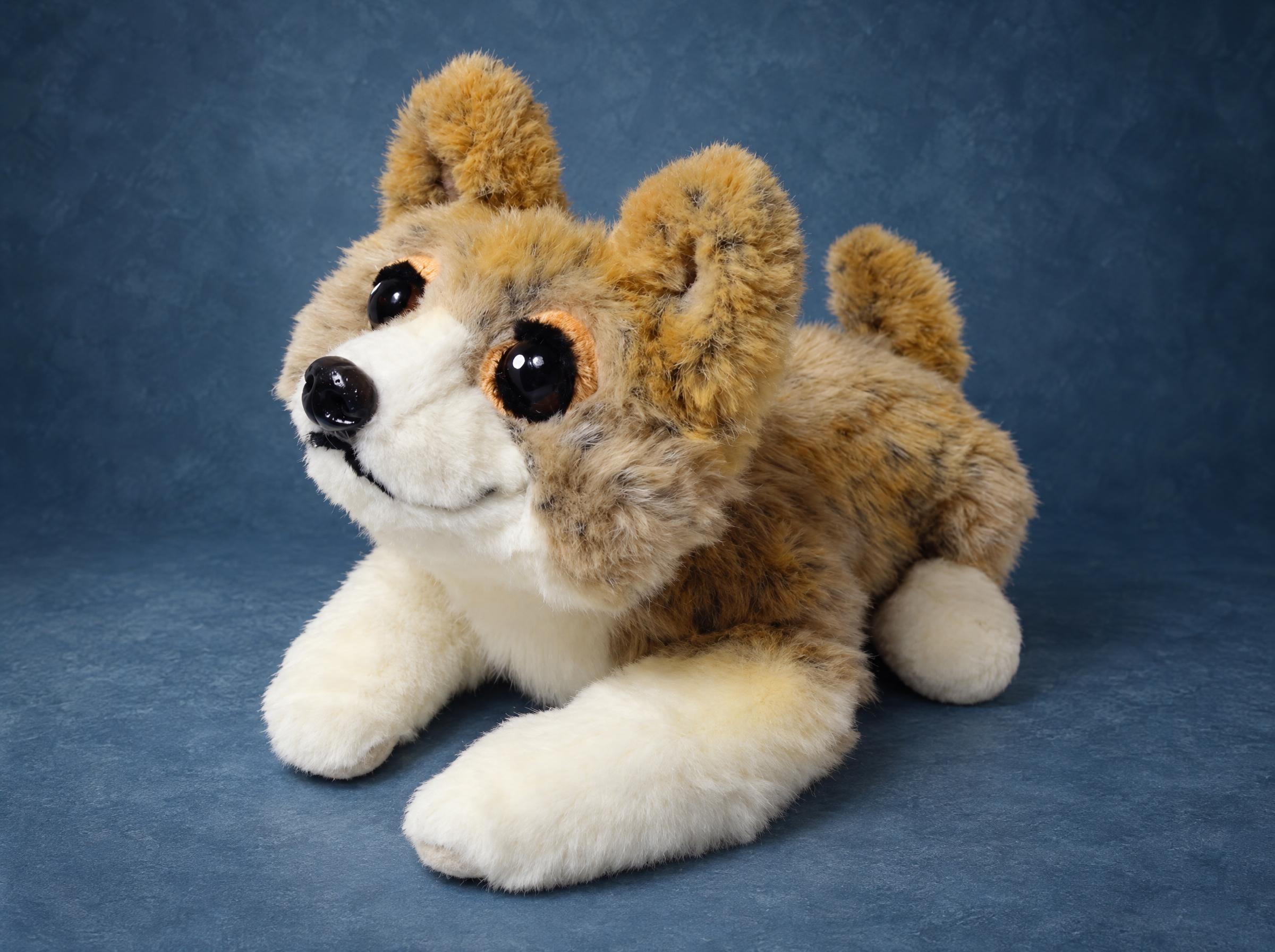 Puppy plush lying down in tan and cream faux fur with big amber-rimmed eyes, handmade to order