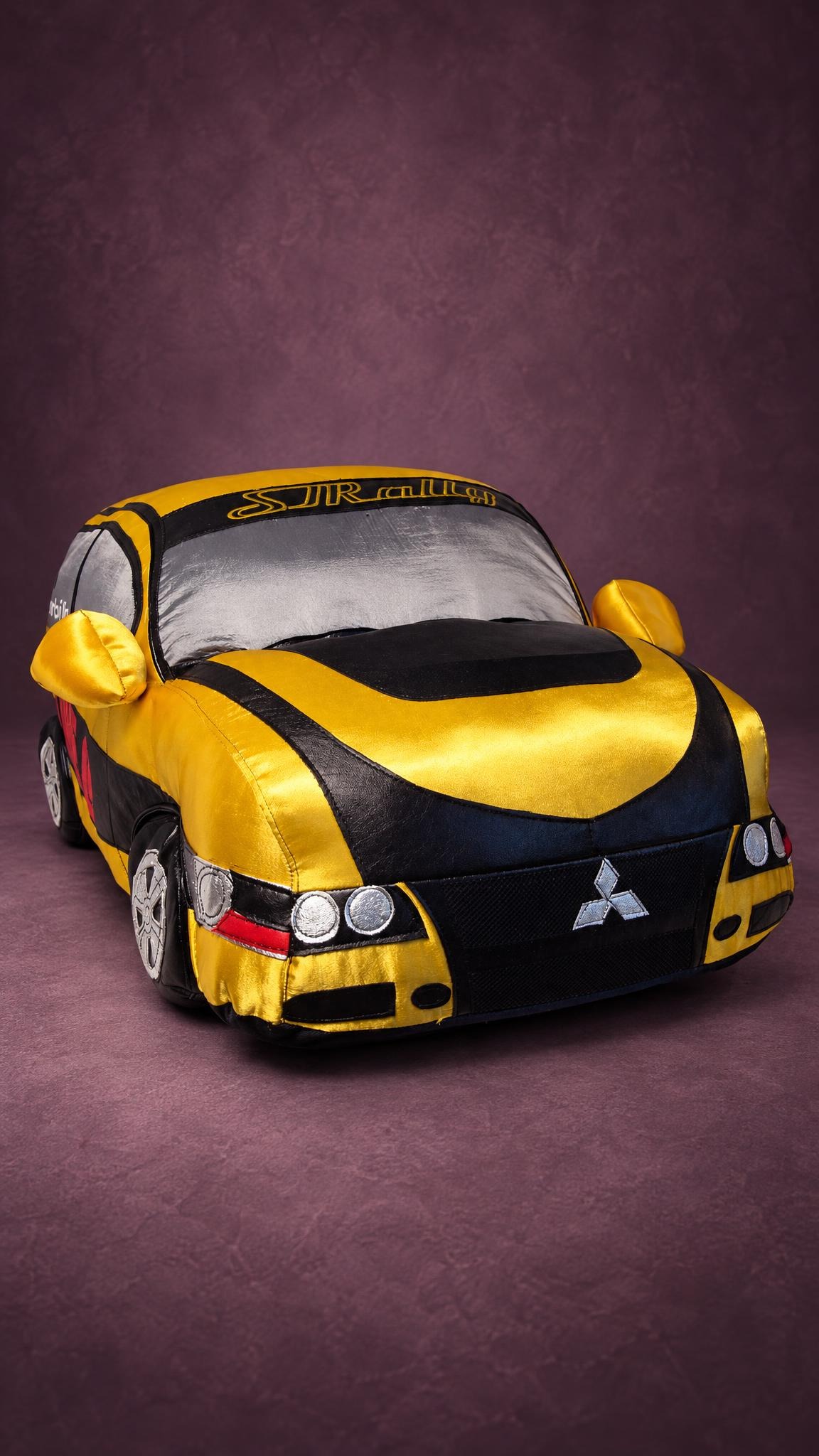 Yellow Mitsubishi rally car plush with an embroidered badge and silver headlights, sewn by hand to order