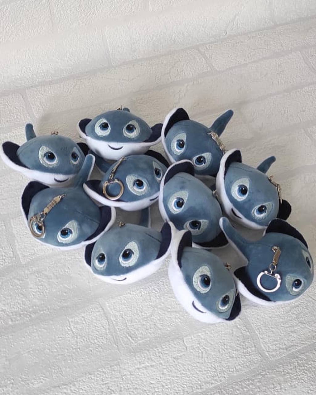Custom stingray plush keychains, sewn in a batch Pile of custom stingray plush keychains with ball chains, rings and embroidered eyes, sewn to order in a batch