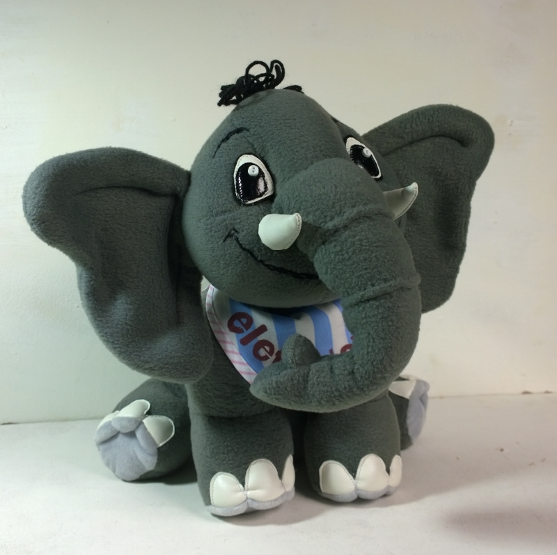 Elephant plush from a client picture Elephant plush from a client picture, handmade to order: trunk curled over the name bib, pale grey soles