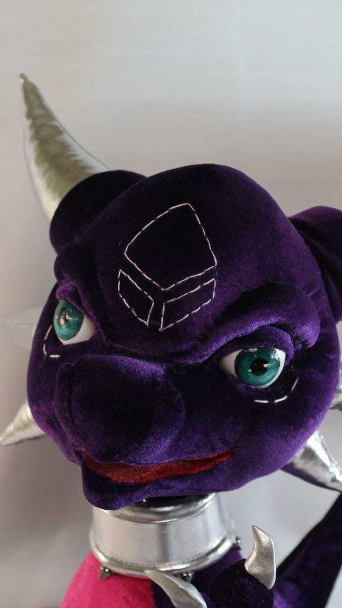 Cynder plush face with stitched forehead marking, teal eyes and silver horns, custom Spyro dragon to order