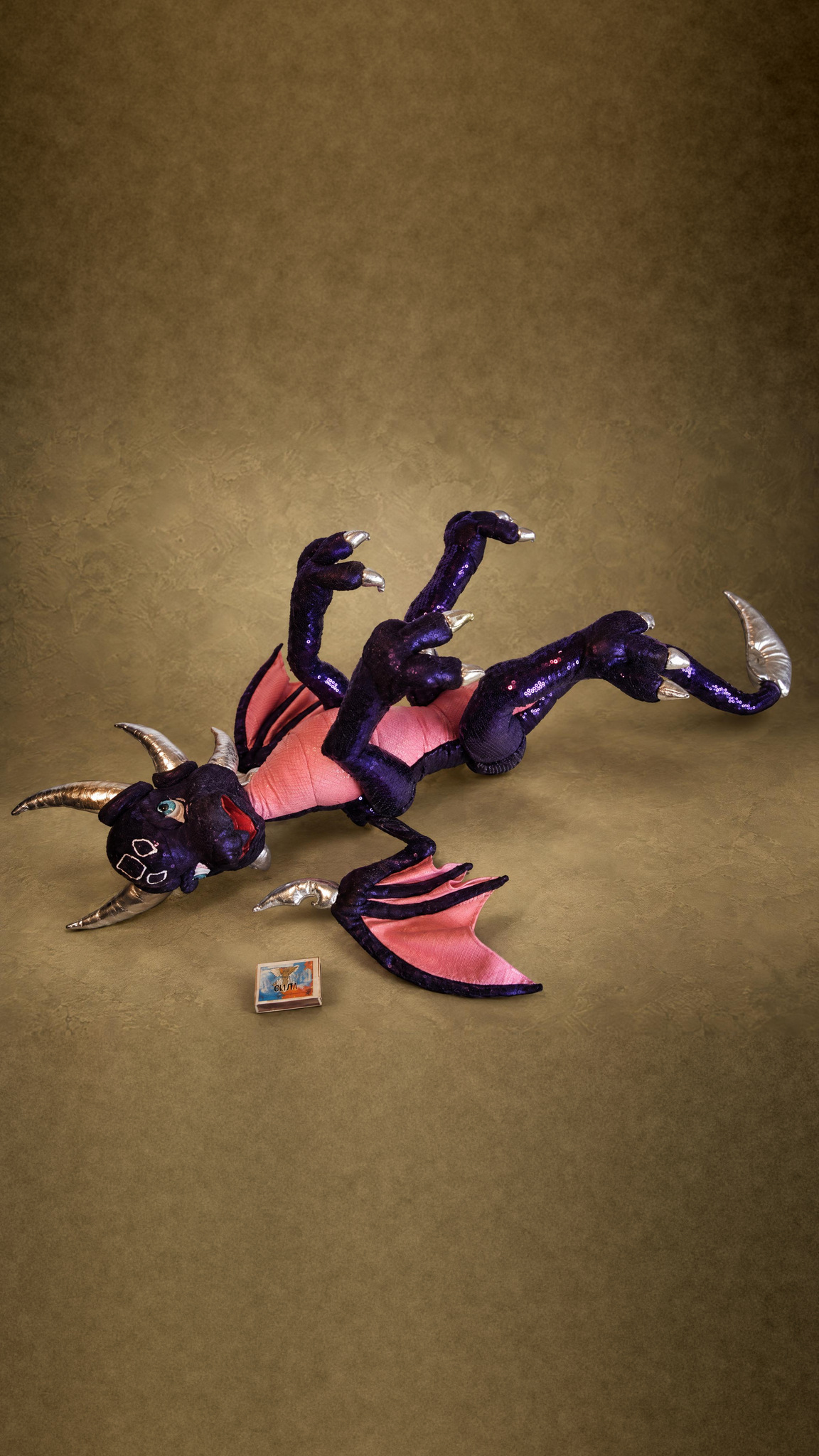 Poseable Cynder plush lying on her back with all four legs bent, a custom Legend of Spyro dragon plush