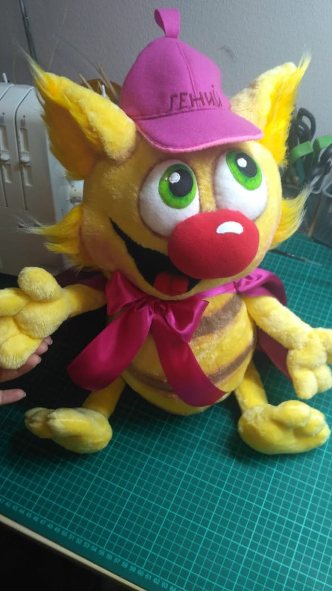 Da Vinci the cat plush in the workshop with cap, cape and big red nose, made to order from a children's book
