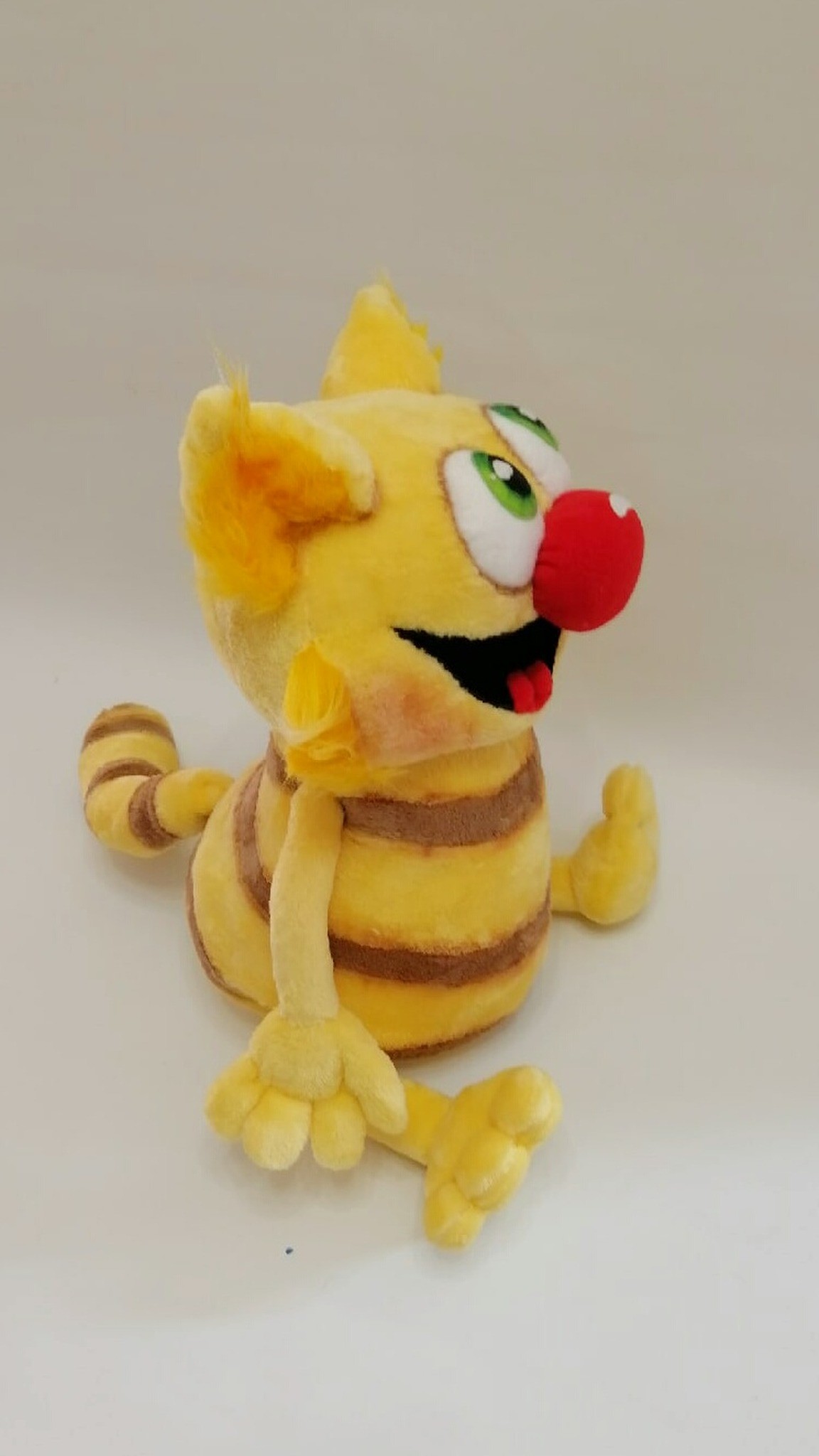 Da Vinci cat plush with tufted yellow ears, wide grin and striped tummy, a custom book character plush