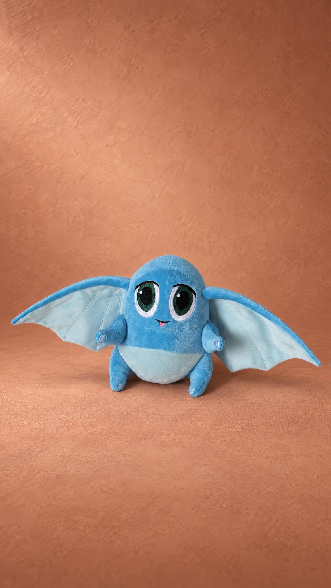 Handmade blue creature plush with wing-like ears and a tiny pink tongue, sewn to order from a designer's sketches