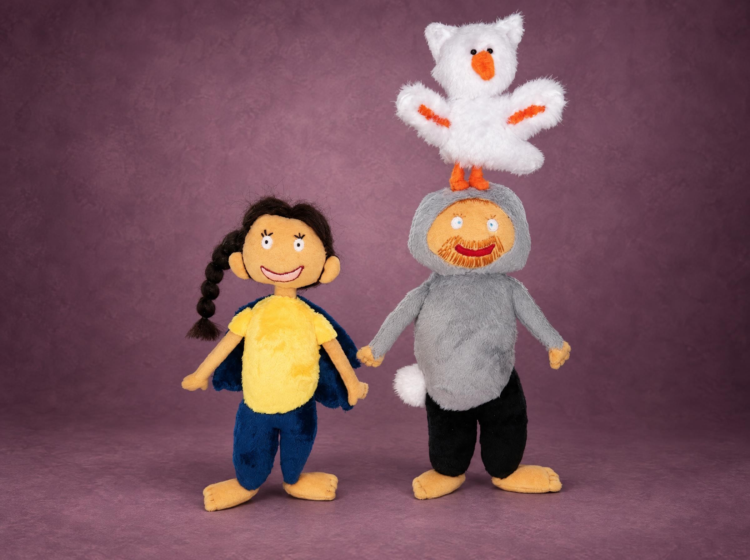 Family dolls made from a child's drawing: a girl with a braid, a bearded man and a white bird, sewn to order