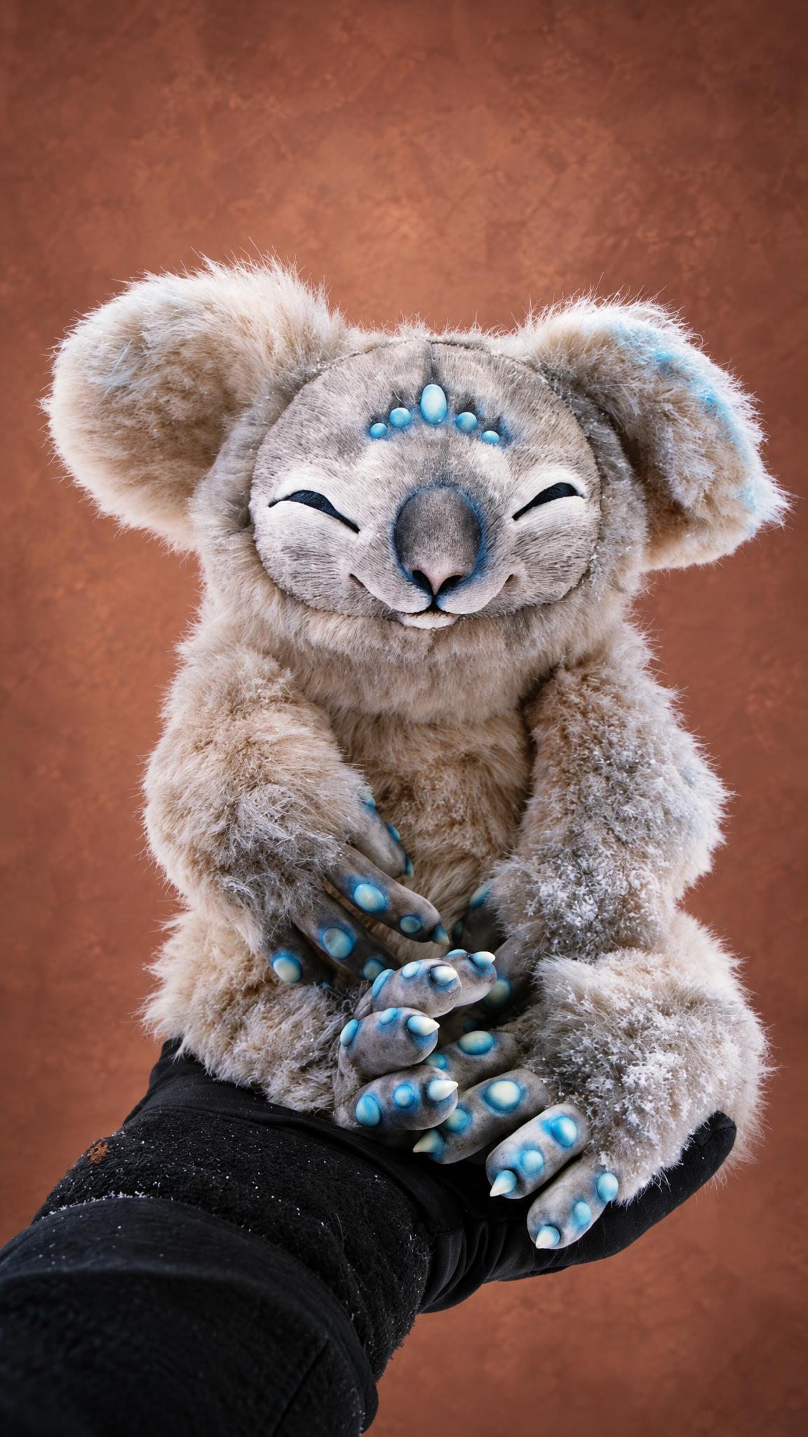 Handmade fantasy koala plush with sleepy closed eyes and a row of turquoise spots on his forehead