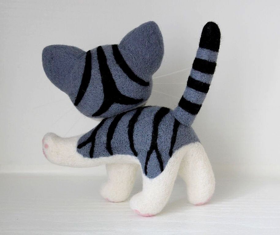Chi’s tabby stripes and ringed tail Felted Chi plush seen from behind, black tabby stripes over grey-blue wool and a ringed black-tipped tail, handmade