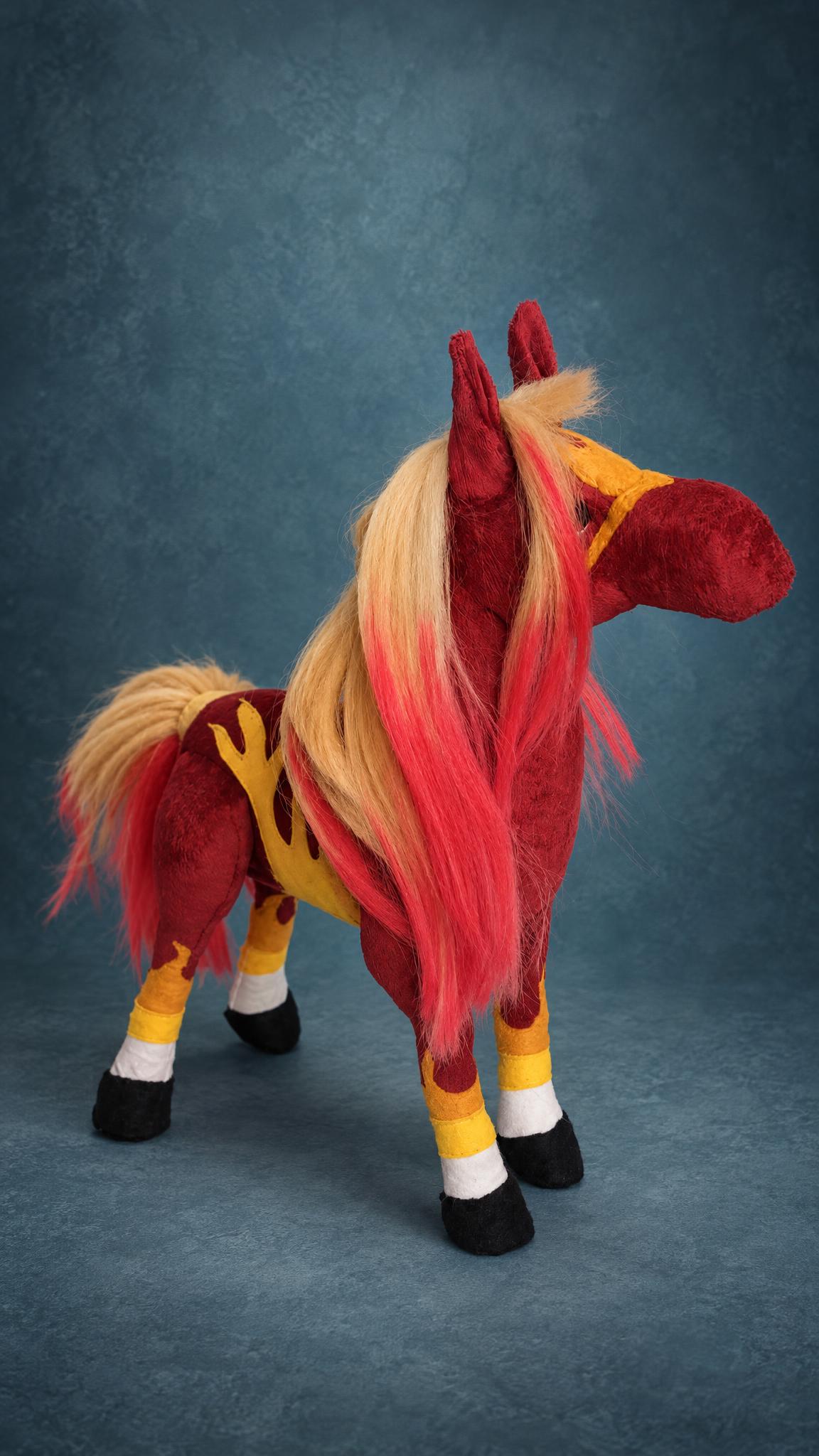 Handmade fire horse plush standing with its head turned, yellow halter and flames up the legs, custom made