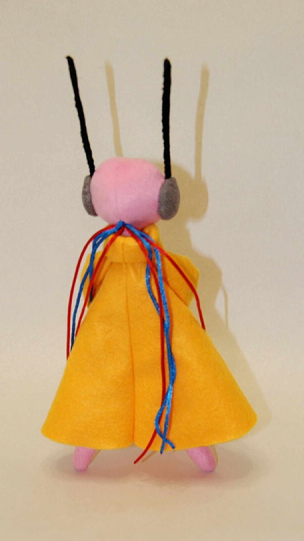 Handmade Five Pebbles plush from Rain World, yellow robe with red and blue cords down the back, sewn to order
