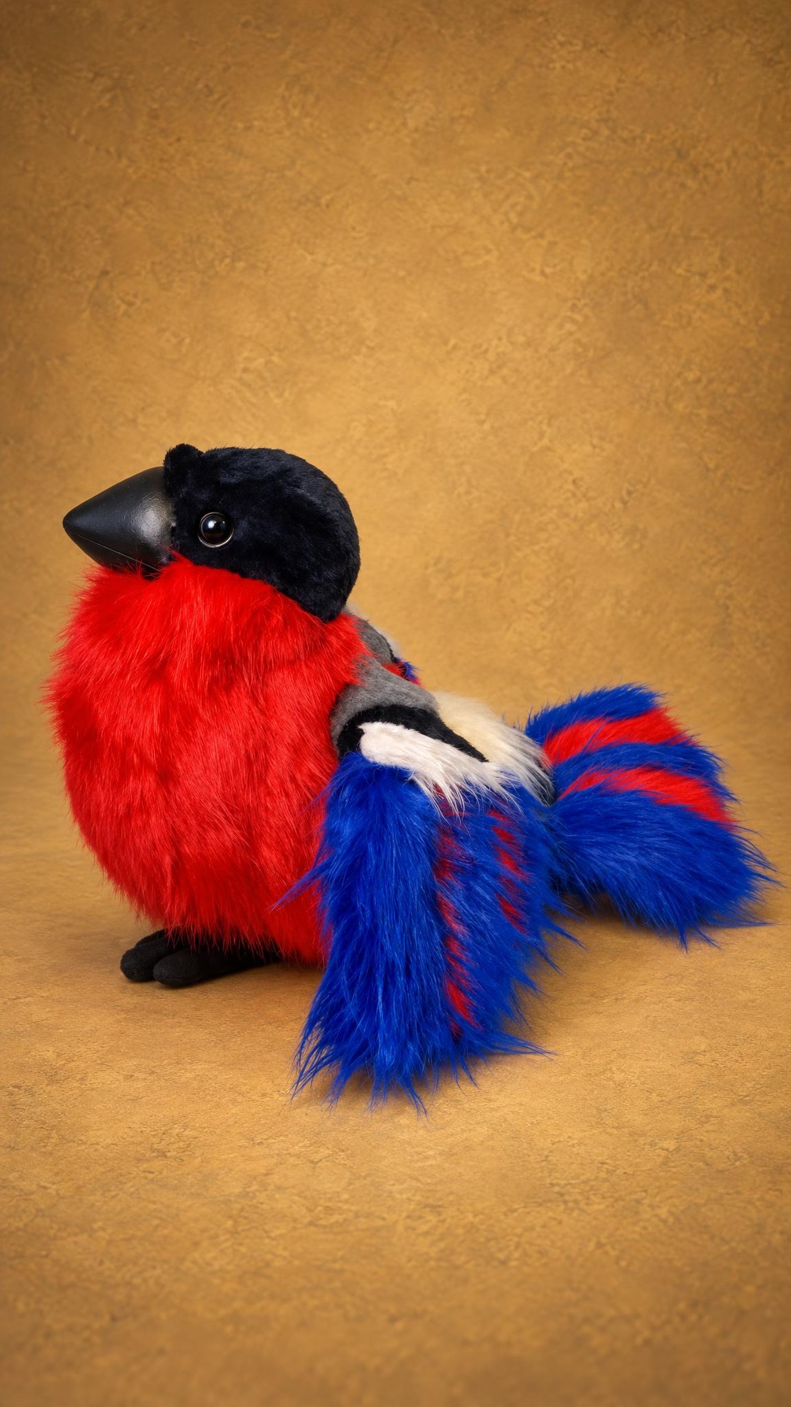 Fluffy bullfinch plush with a shaggy red breast and a royal blue tail with red stripes, made to order