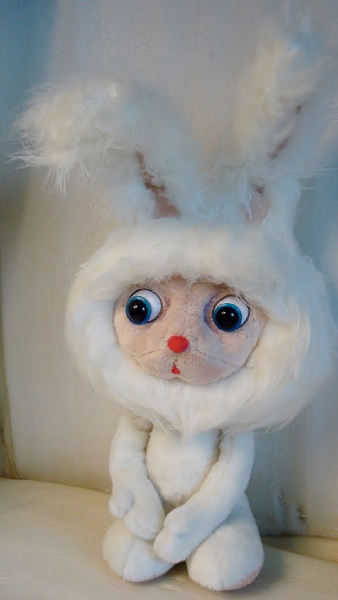 Fluffy cartoon bunny plush with paws folded and a white faux fur hood, custom made to order