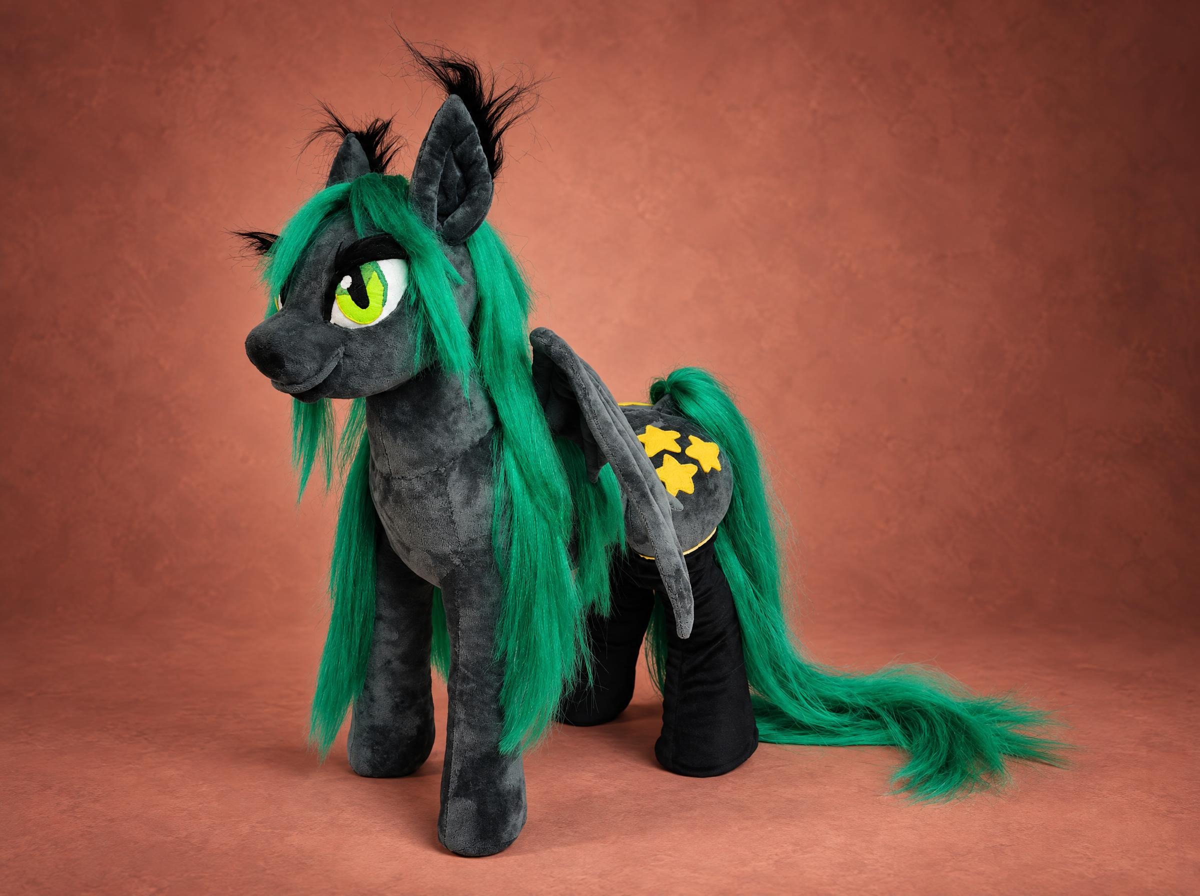Fluffy Star, a custom MLP bat pony plush in graphite grey with a long green mane, handmade to order