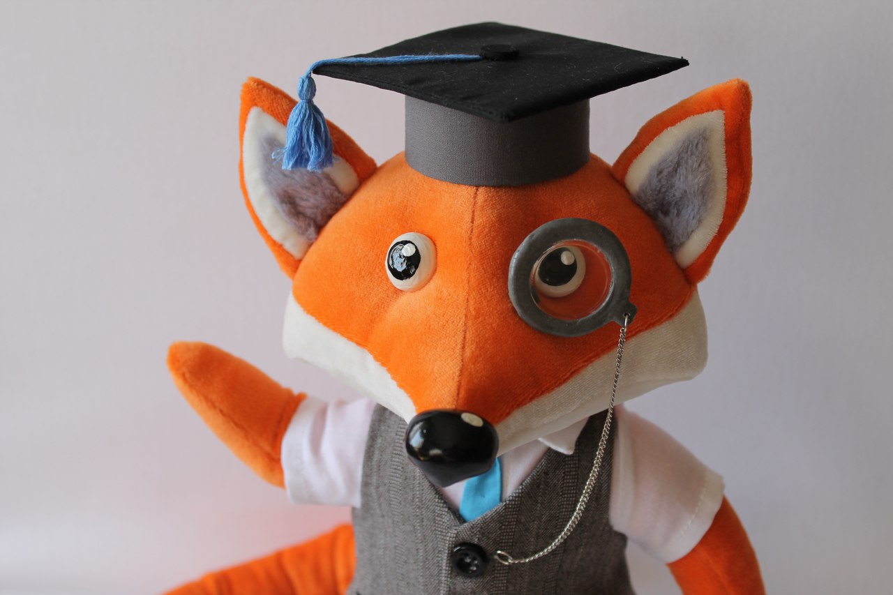 Fox mascot plush with a monocle Corporate fox mascot plush with a hand-sculpted monocle and a graduation cap with blue tassel, made to order