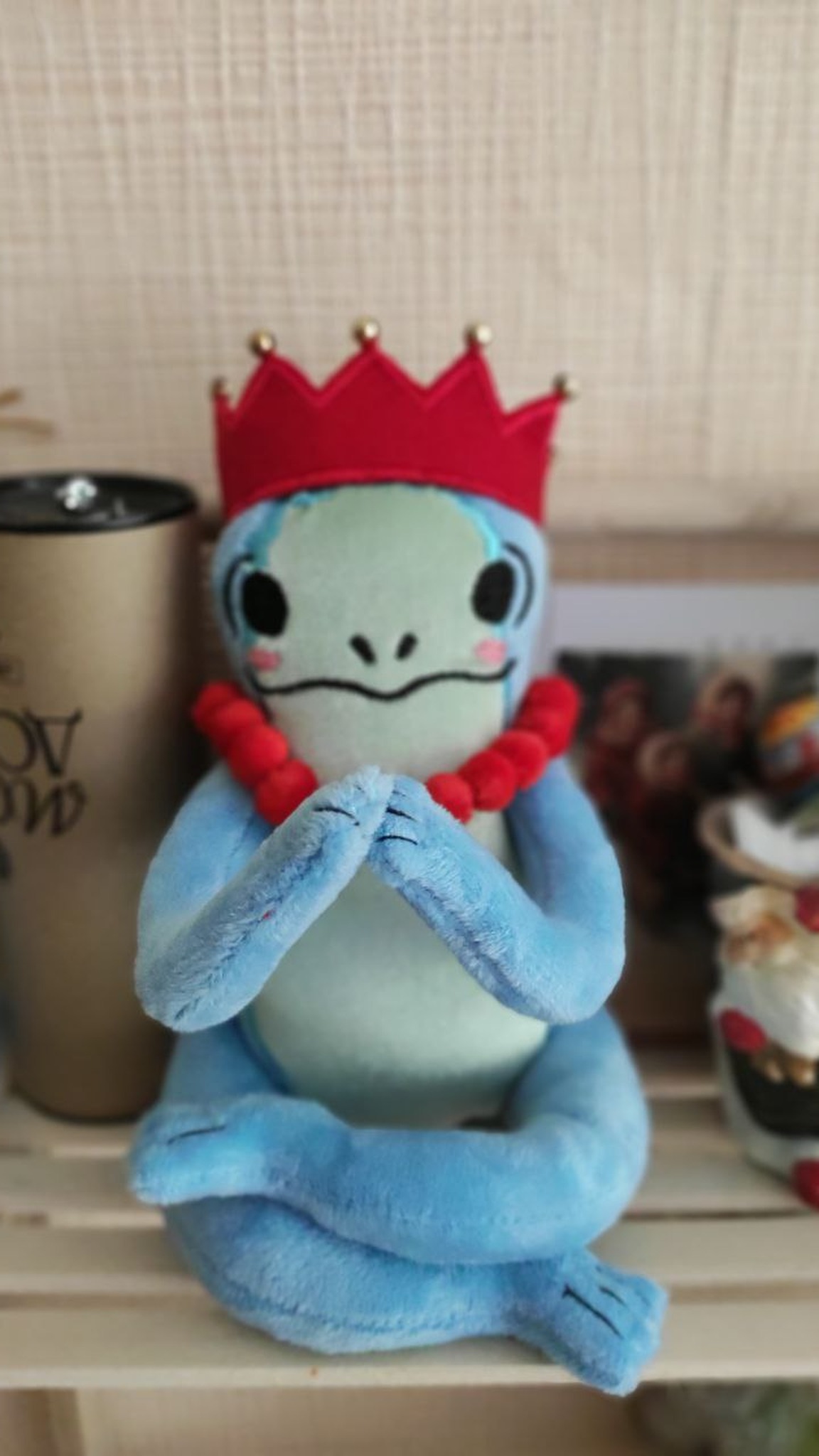 Frog plush with crossed legs and hands pressed together, red crown, handmade frog princess from a sticker
