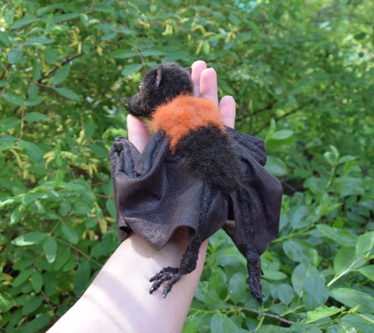Fruit bat plush with orange mantle Fruit bat plush seen from the back, orange faux fur mantle and folded dark wings, handmade bat toy to order