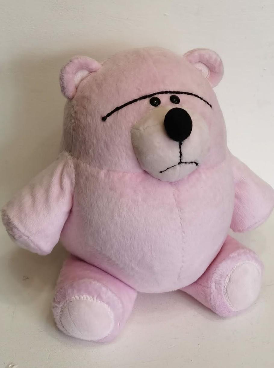 Fur Bear plush with a grumpy face Fur Bear plush with a grumpy face, one long stitched brow over two black button eyes, Toy Story fan toy