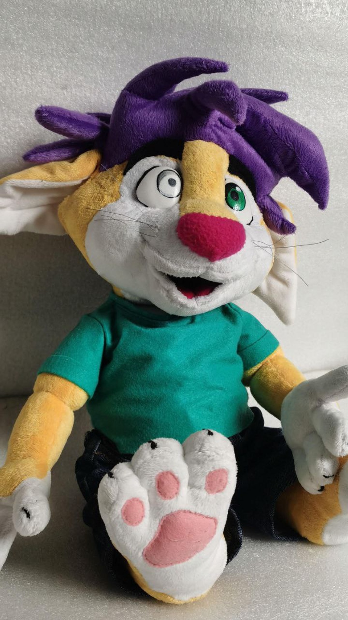 Furry fox plush sitting with feet up, pink paw pads, purple hair and odd eyes, sticker character made to order