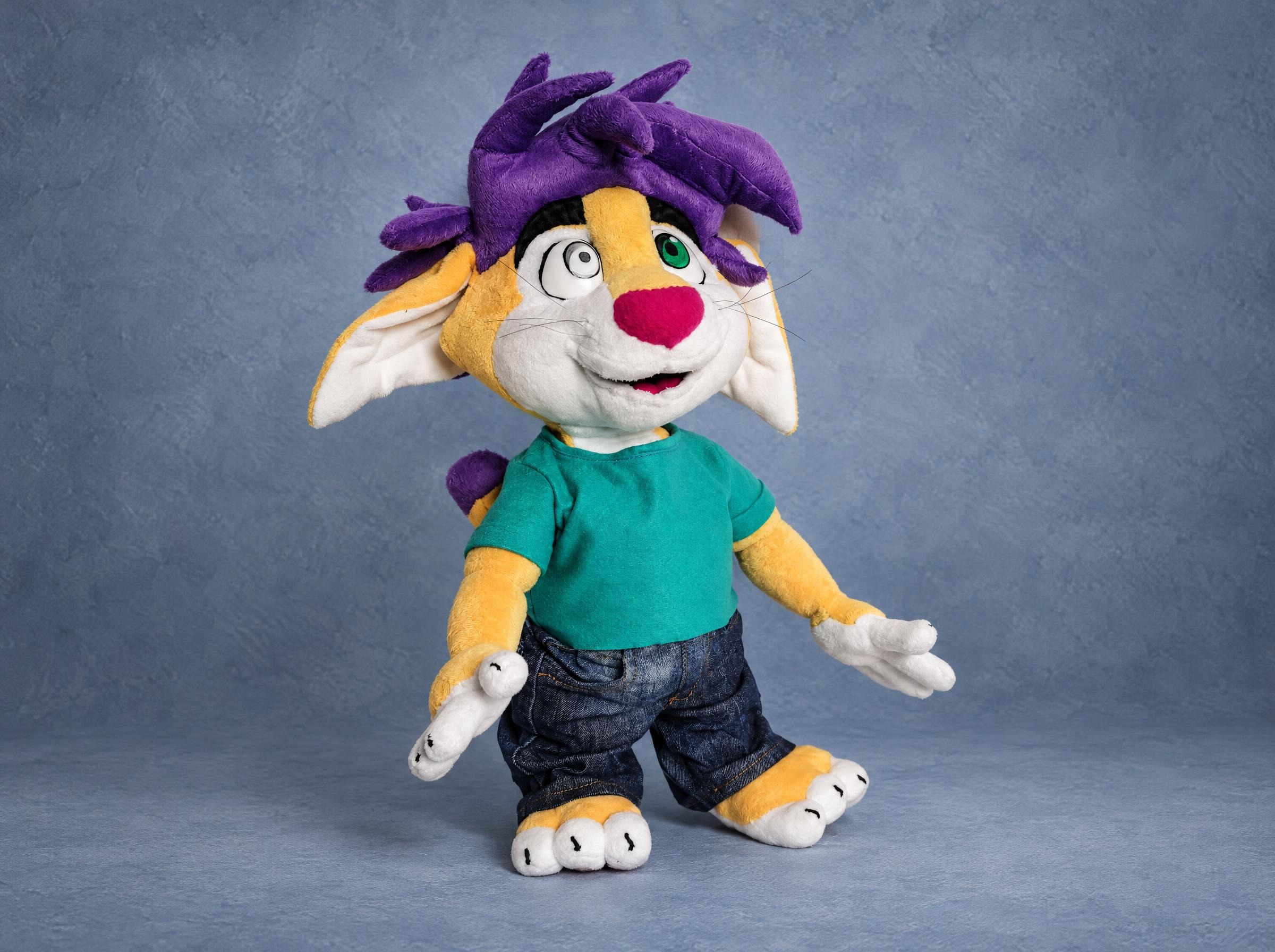 Furry fox plush made to order from a sticker: yellow fox with purple hair, teal T-shirt and denim jeans