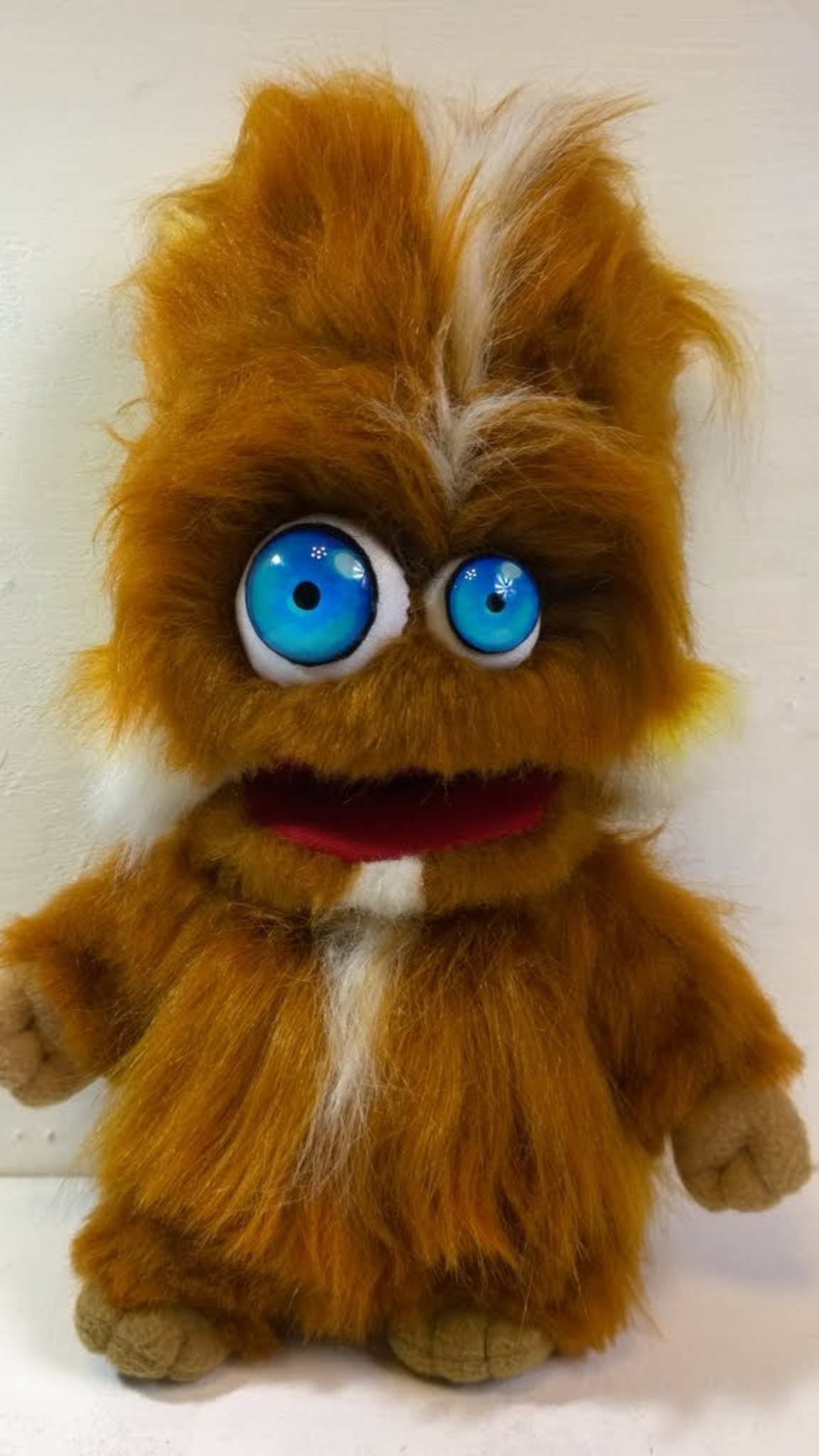 First version of the furry monster plush: ginger faux fur, big blue eyes and a red open mouth, sewn to order