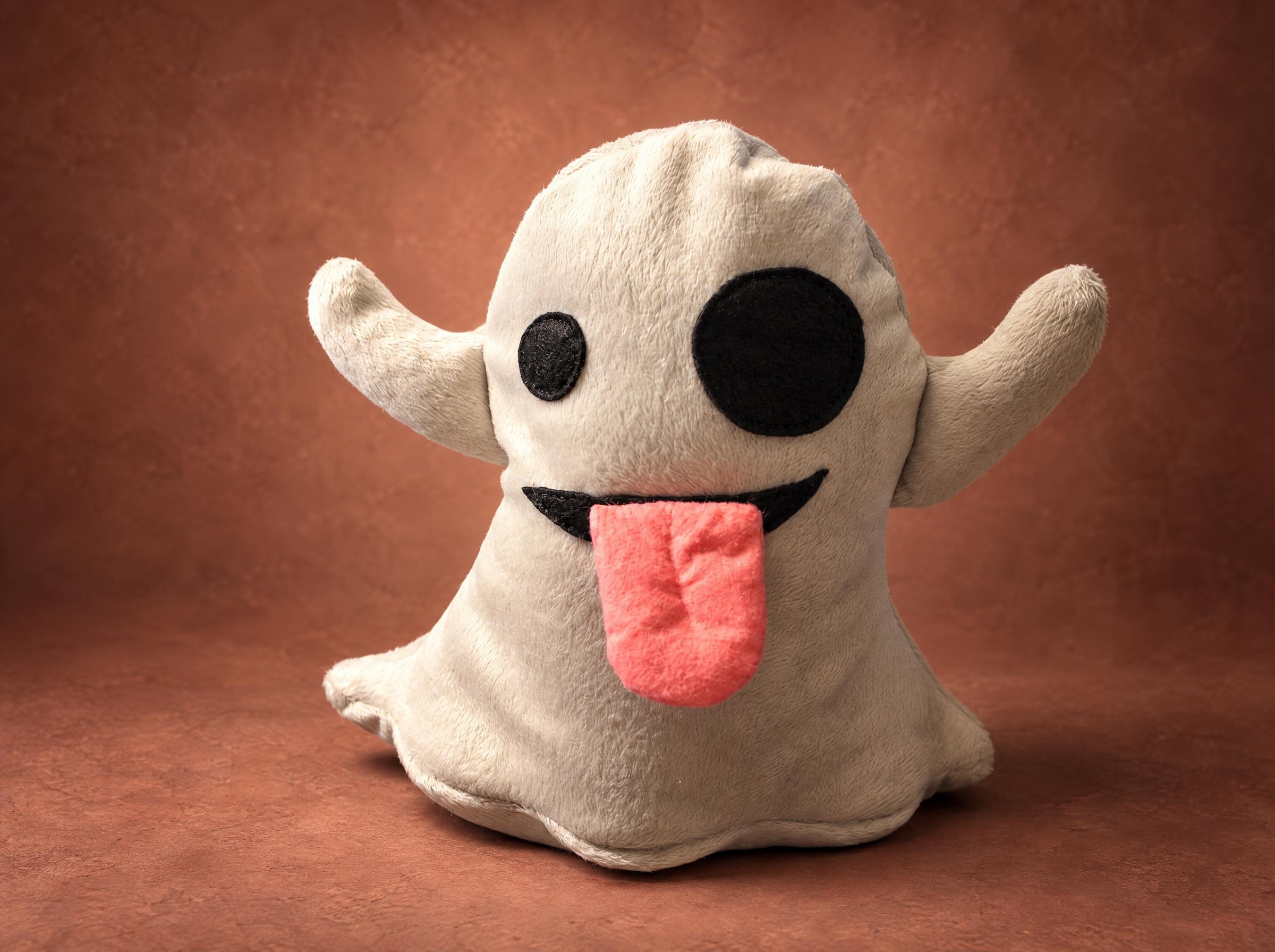 Ghost emoji plush sewn by hand to order: grey-white plush, raised arms, felt eyes and a pink tongue sticking out
