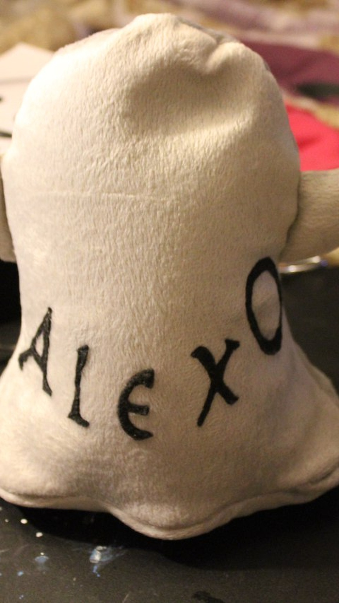 Ghost emoji plush from behind with a name lettered in black, sewn by hand to order for one customer