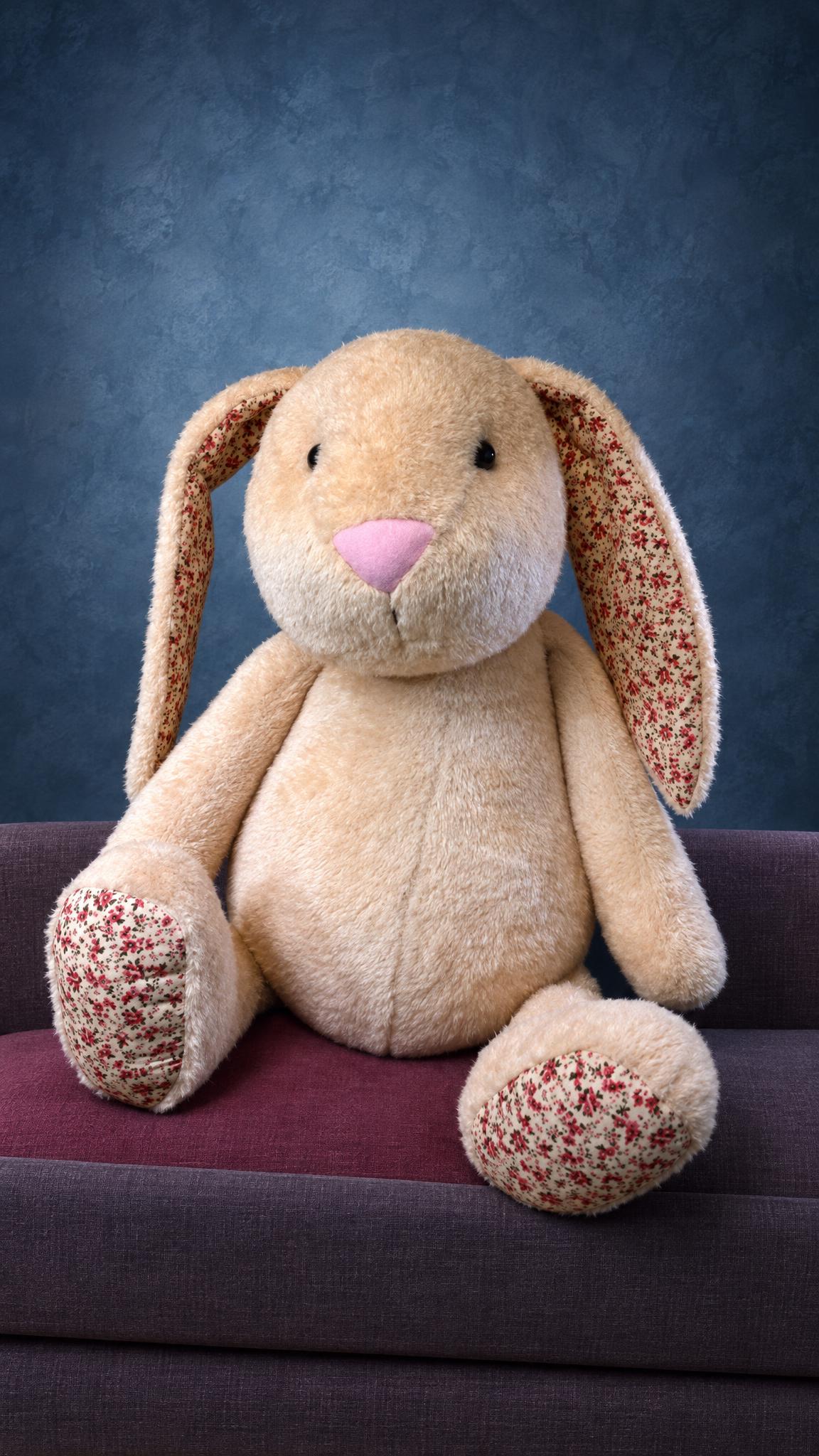 Giant bunny plush sewn to order: peach faux fur, pink nose, floral-lined ears, sitting with its feet out